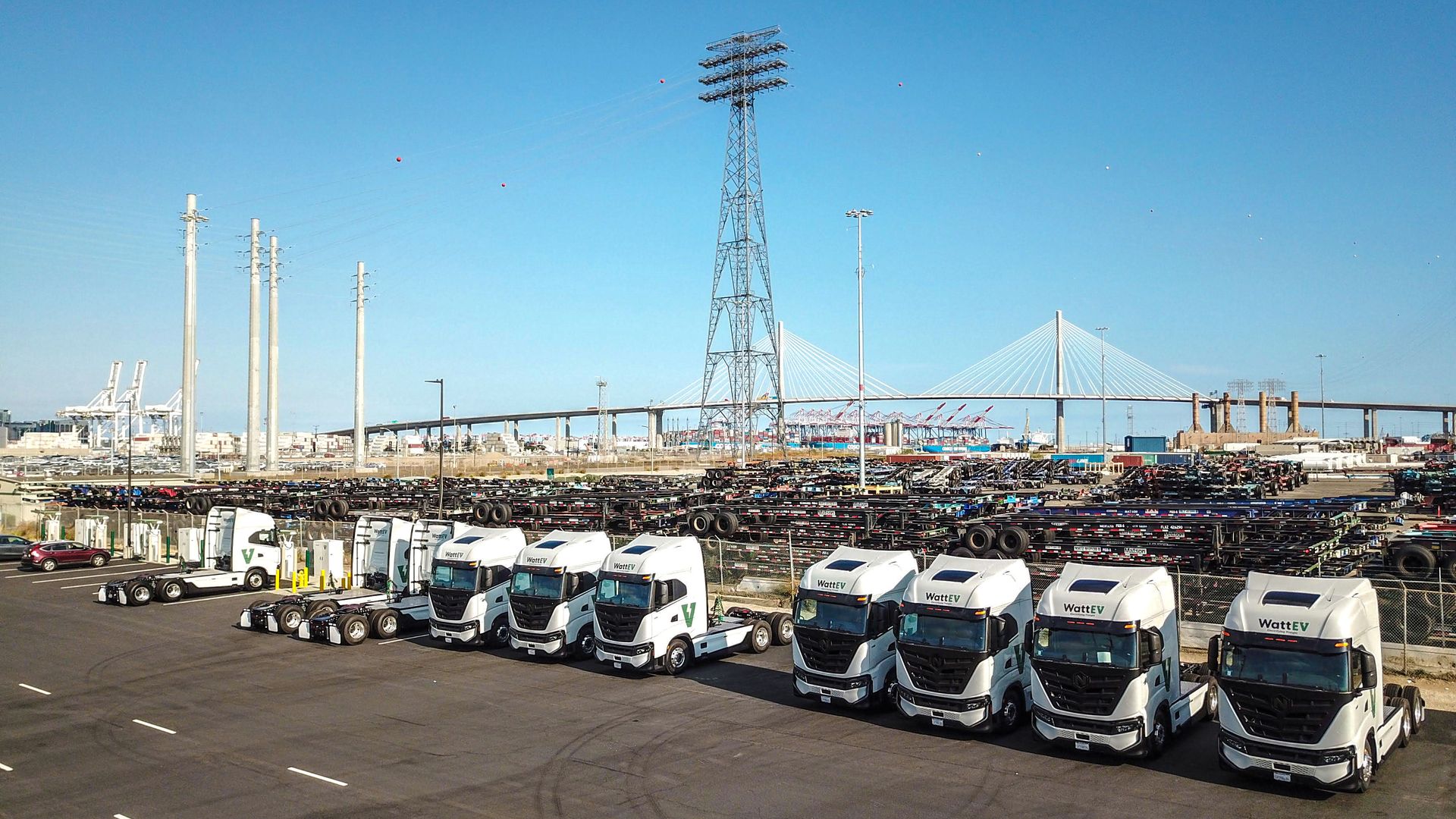 A row in electric trucks at a charging depot in Bakersfield, Calif.