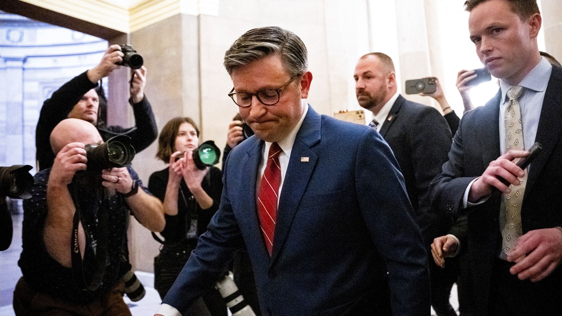 Speaker Mike Johnson at the Capitol with reporters and photographers behind him 
