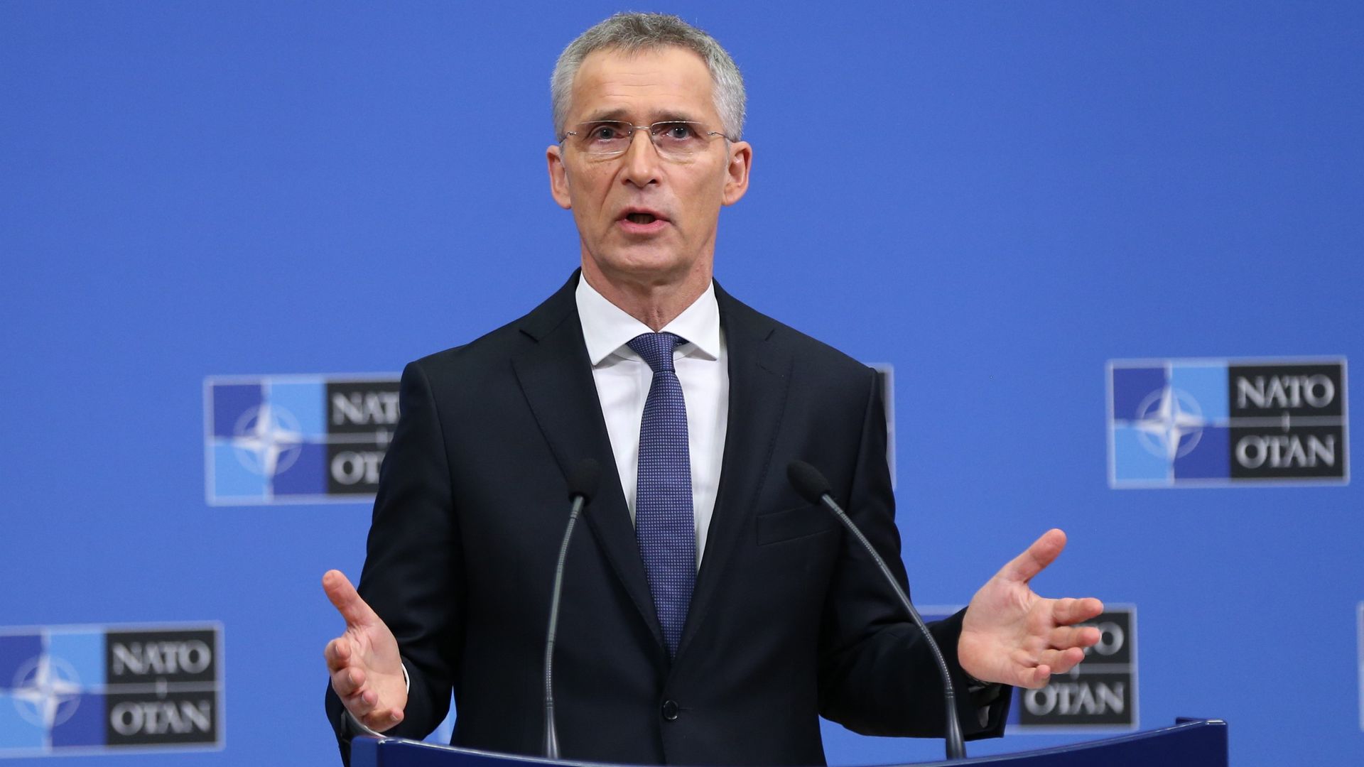 NATO Secretary General Jens Stoltenberg speaking at a lectern
