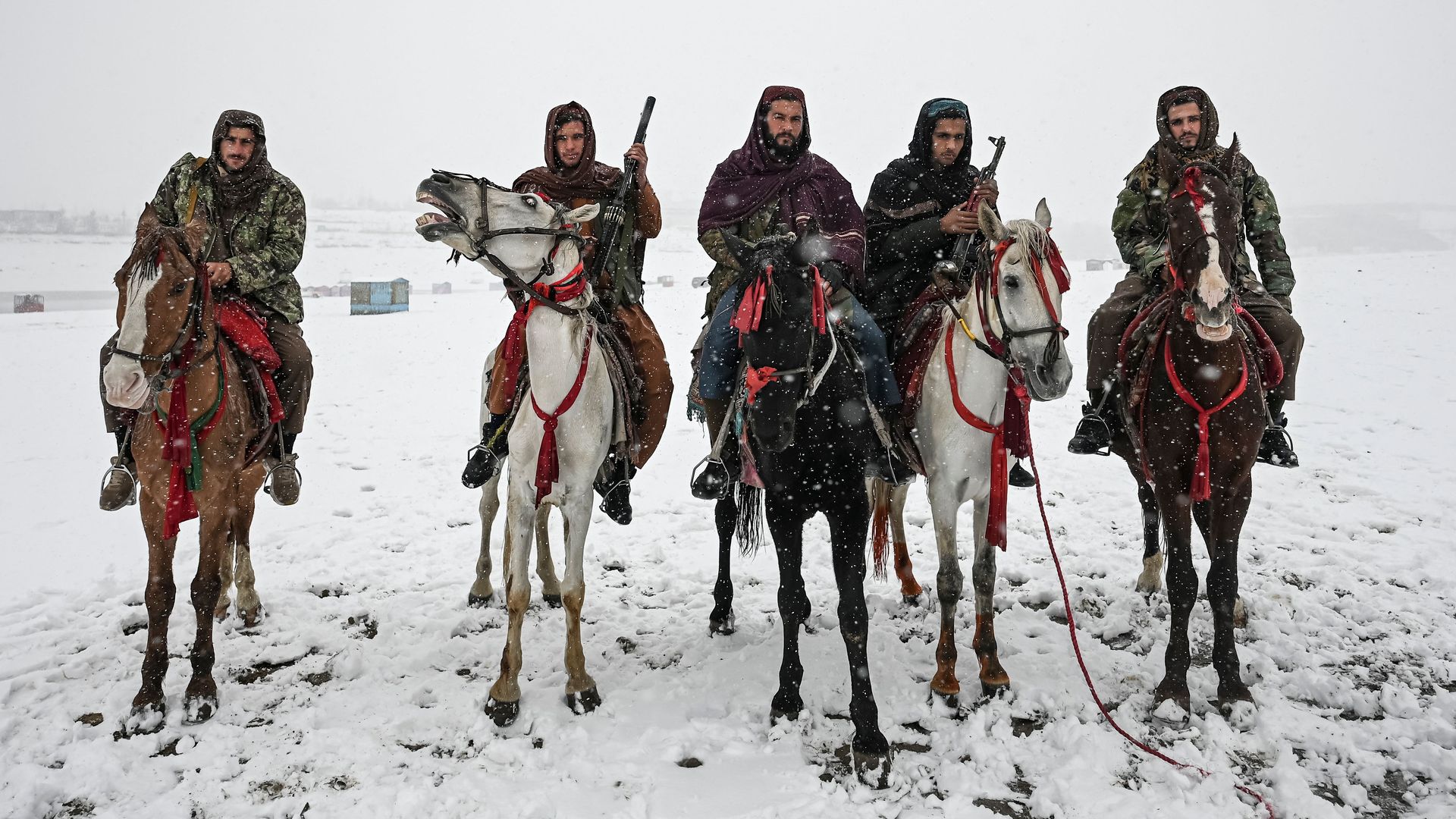  Taliban fighters riding horses during a snowfall at the Qargha lake in Kabul on January 3.