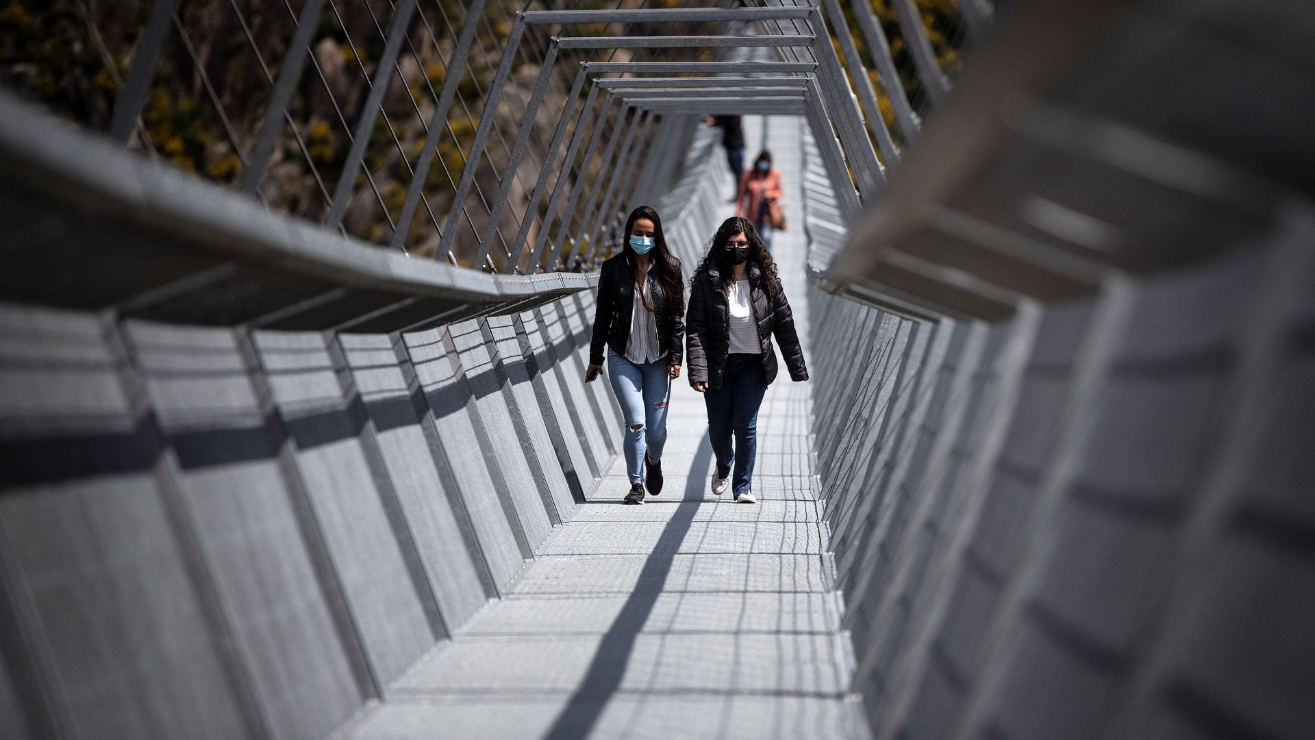 Picture of two women walking on the world's longest pedestrian suspension bridge
