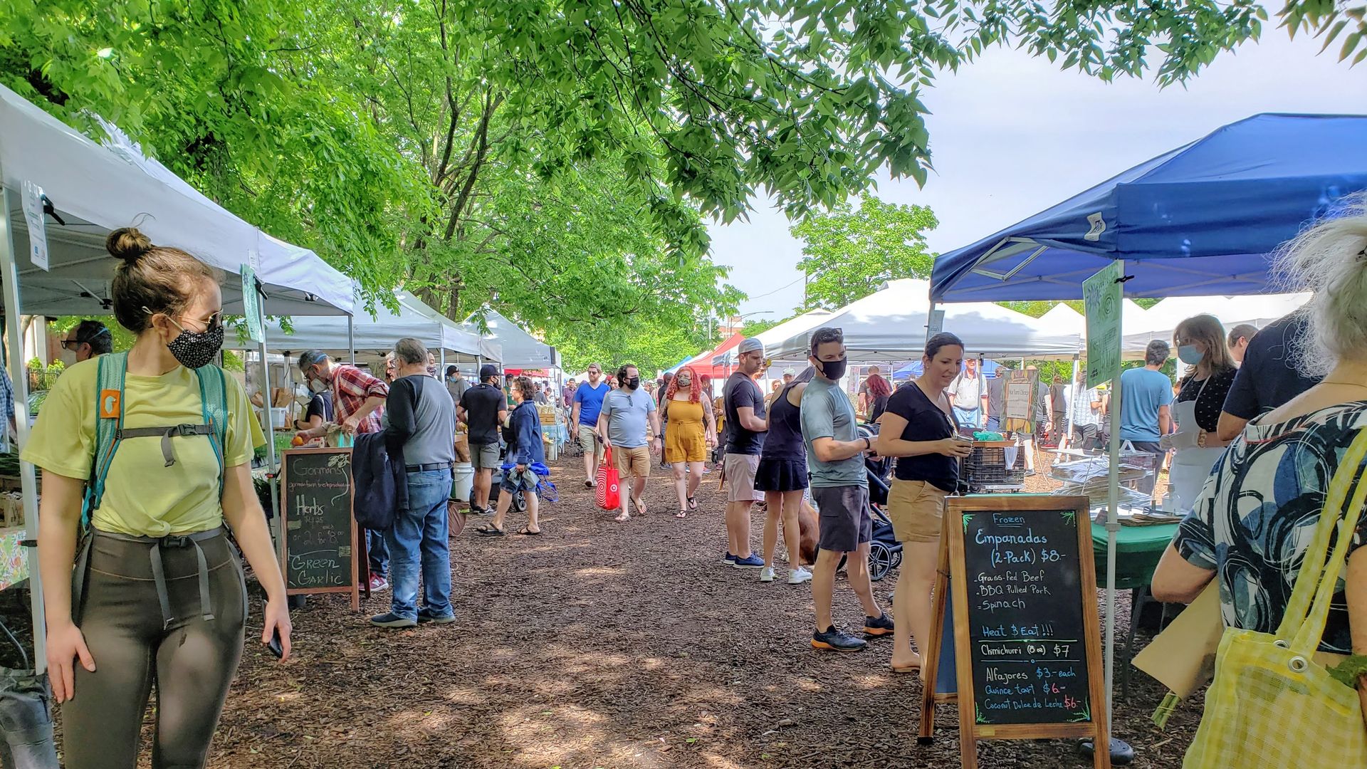 Photo of a farmers market in the park.