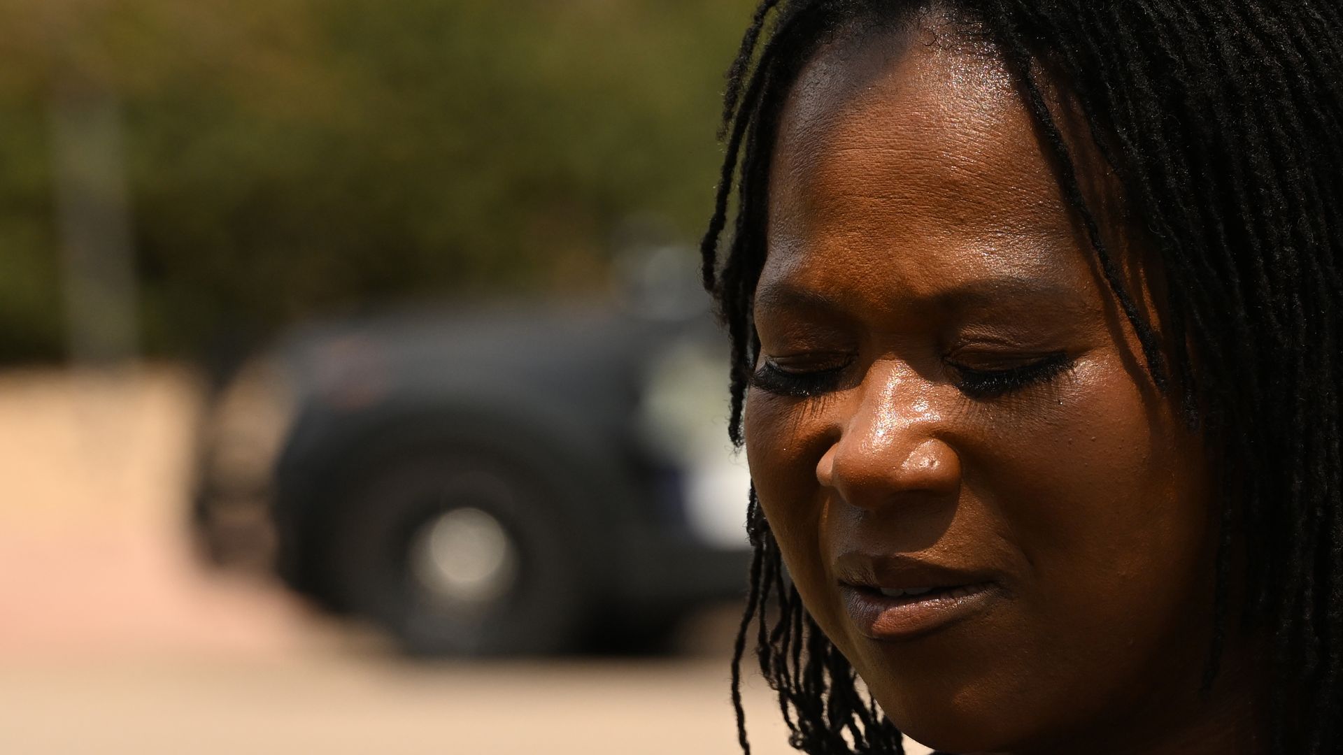 Rajon Belt-Stubblefield's wife, Tandra Blankson, closes her eyes for a moment during a press conference attended by family members and community supporters outside Arapahoe County District Court on Monday, Aug. 3, 2026, in Centennial, Colorado.