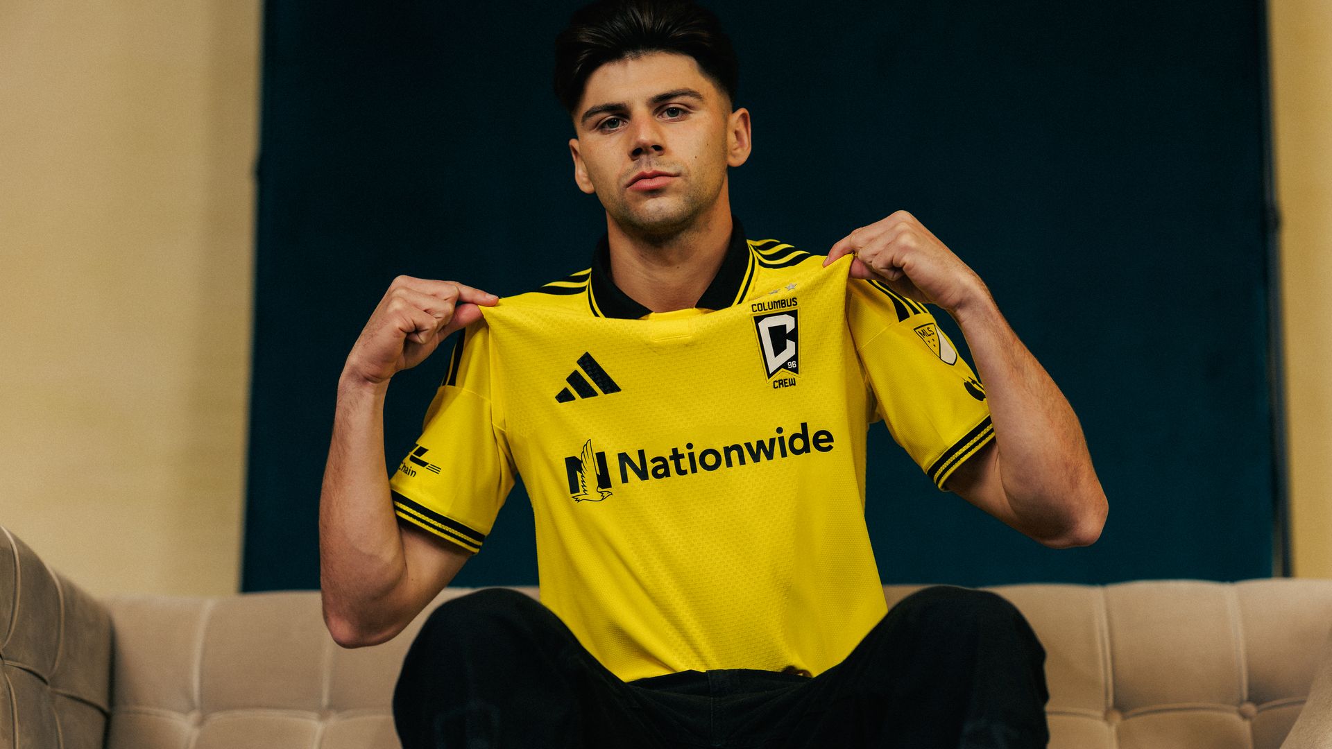 Max Arfsten models the new yellow Columbus Crew jersey