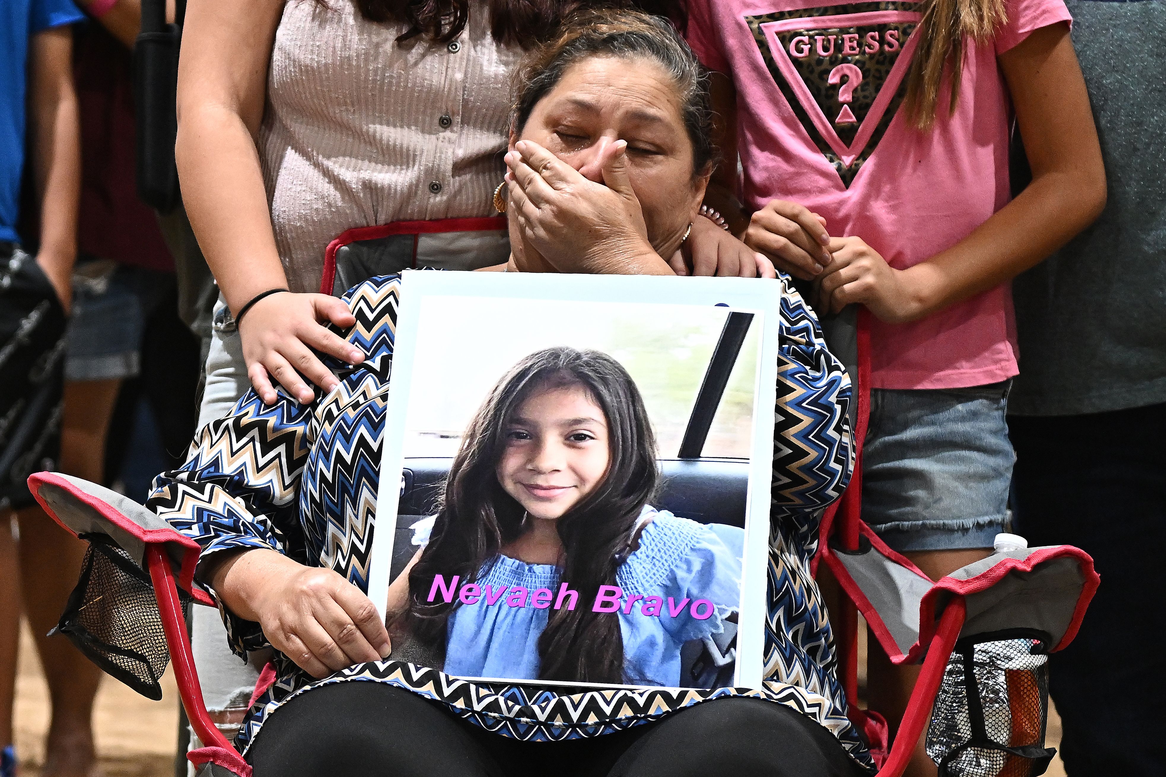 Esmerralda Bravo holds a picture of her grandaughter Naveah, a shooting victim, Wednesday at the Uvalde County Fairplex to honor the fallen victims of a mass shooting during a vigil in Texas. 