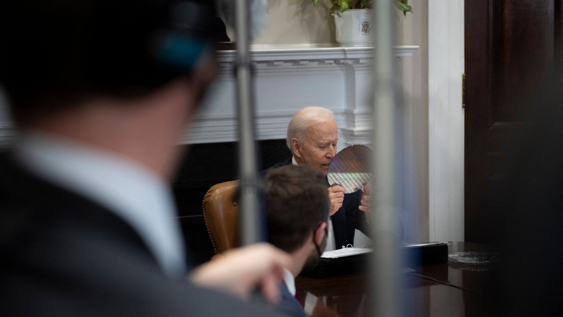 President Biden looks at a silicon disc