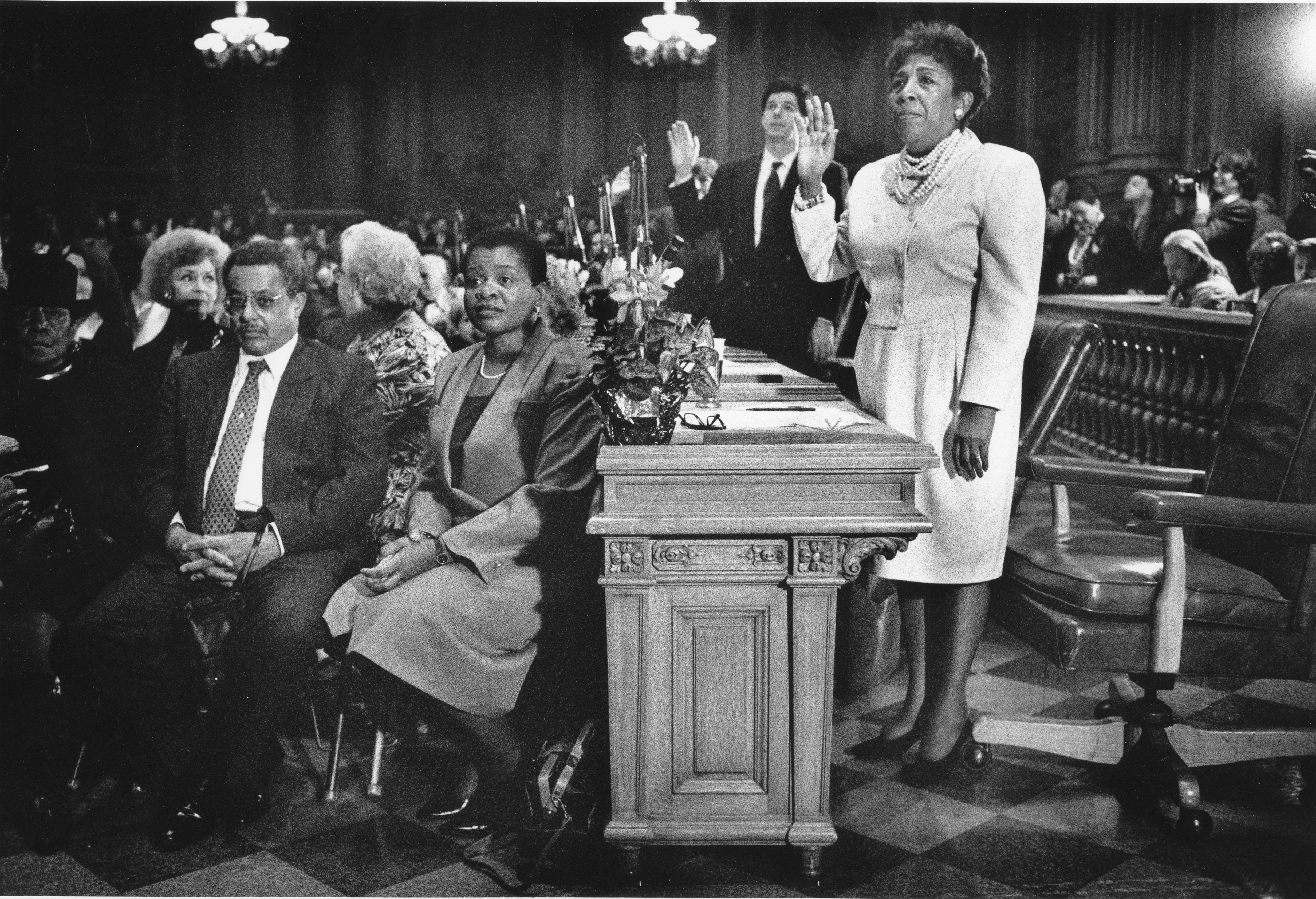 black and white photo of woman being sworn in
