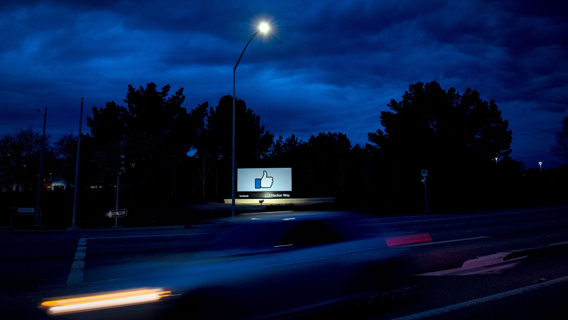The "thumbs up" sign outside of Facebook headquarters, at night