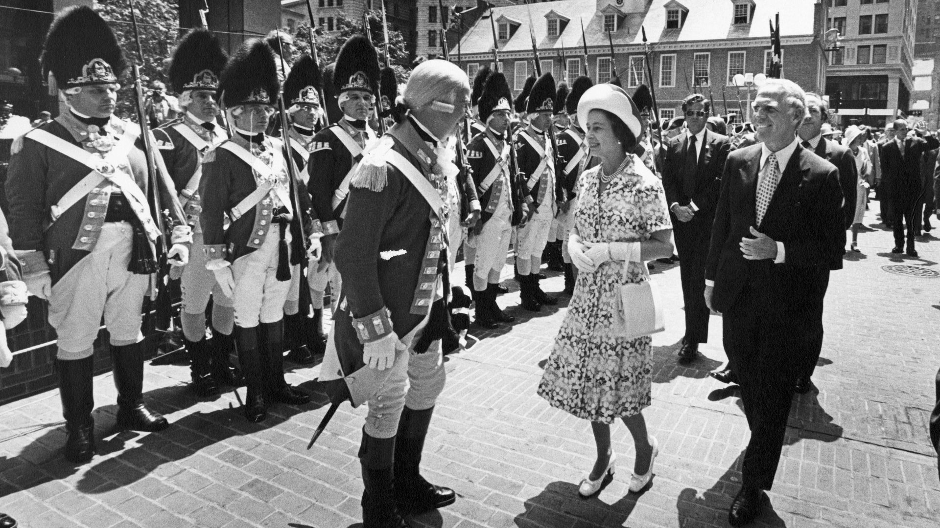 Queen Elizabeth II greets a man dressed in 18th Century British army uniform in Boston in 1976.