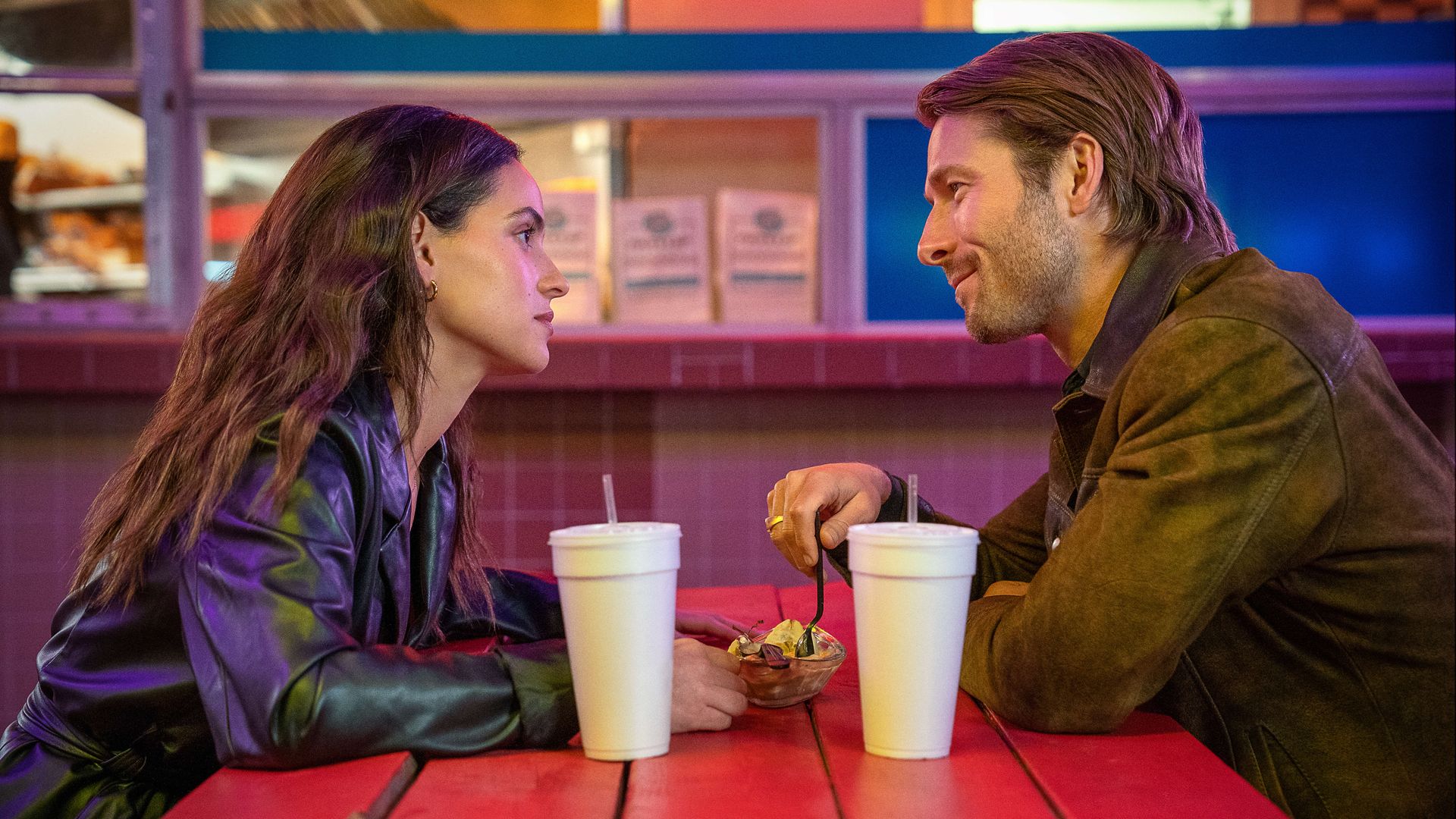 Photo shows Glen Powell and Adria Arjona eating at Ted's Frostop in New Orleans during the "Hit Man" movie.