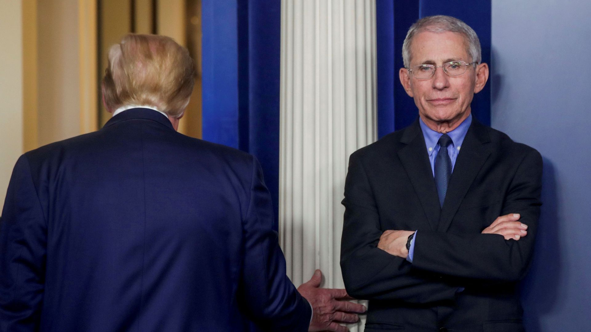 Fauci stands in the White House.
