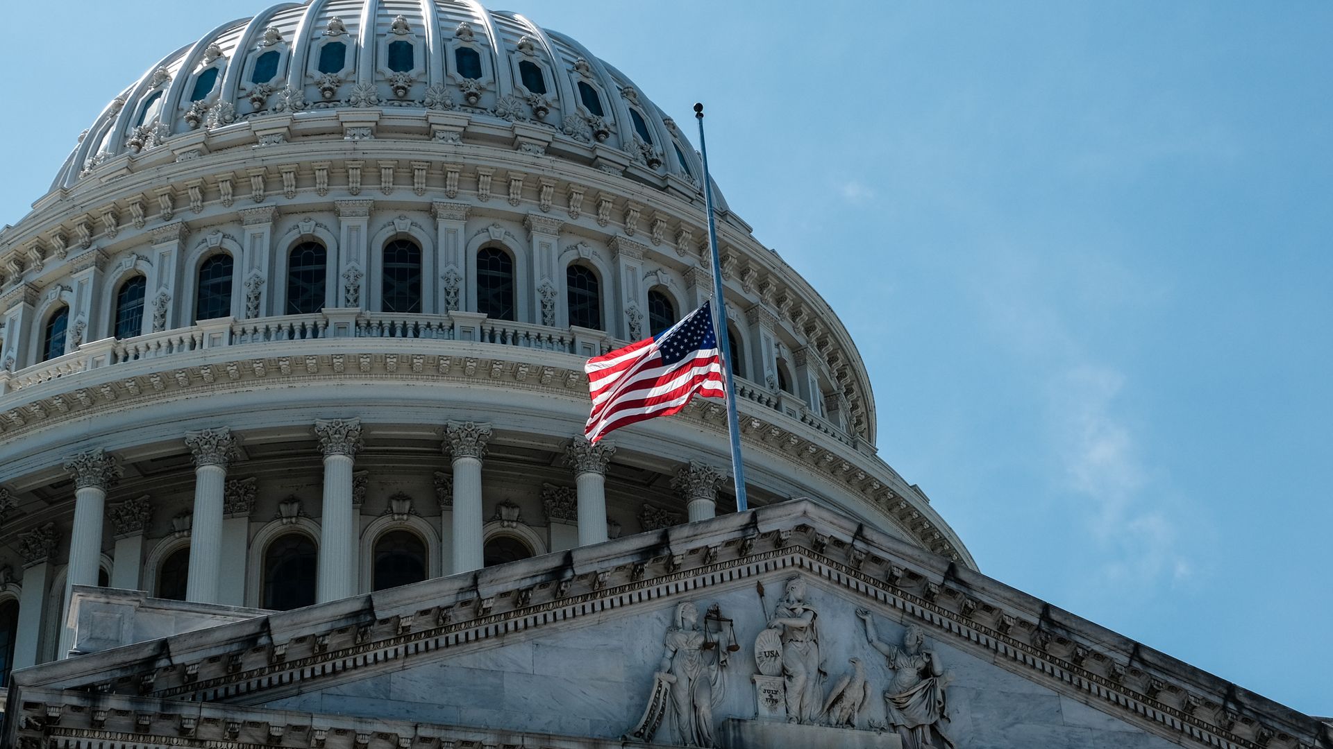 An American flag outside of the U.S. Capitol lowered to half staff to honor the life of Rep John Lewis