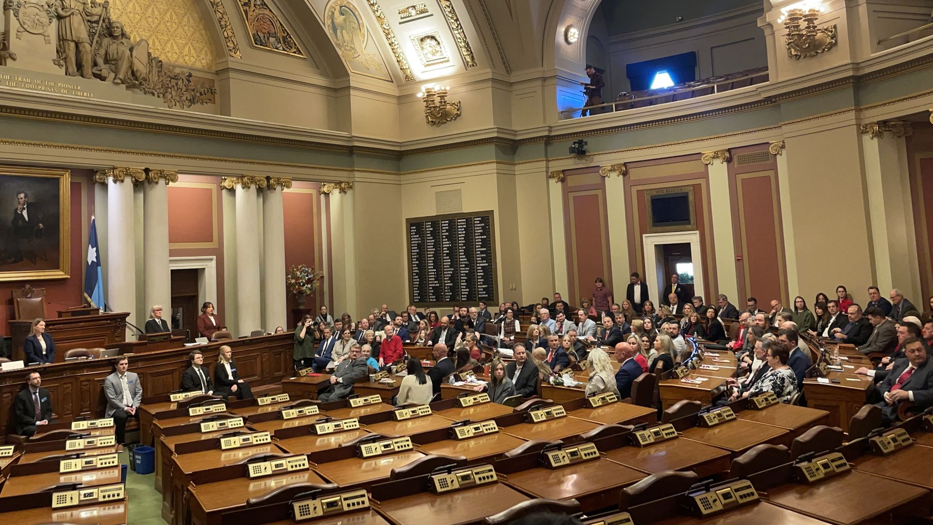 The Minnesota House chamber with only half desks filled