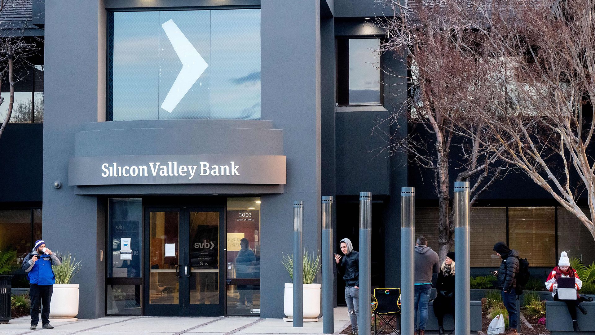 Silicon Valley Bank customers line up before the opening of a branch at SVBs headquarters in Santa Clara, California, on March 13, 2023