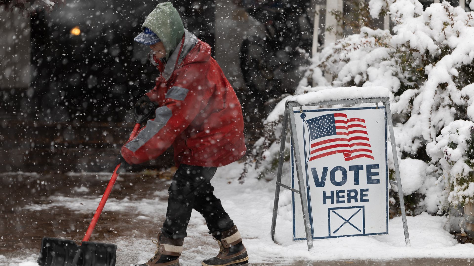 A Washoe County employee shovels snow outside of a vote center on November 8, 2022 in Reno, Nevada.