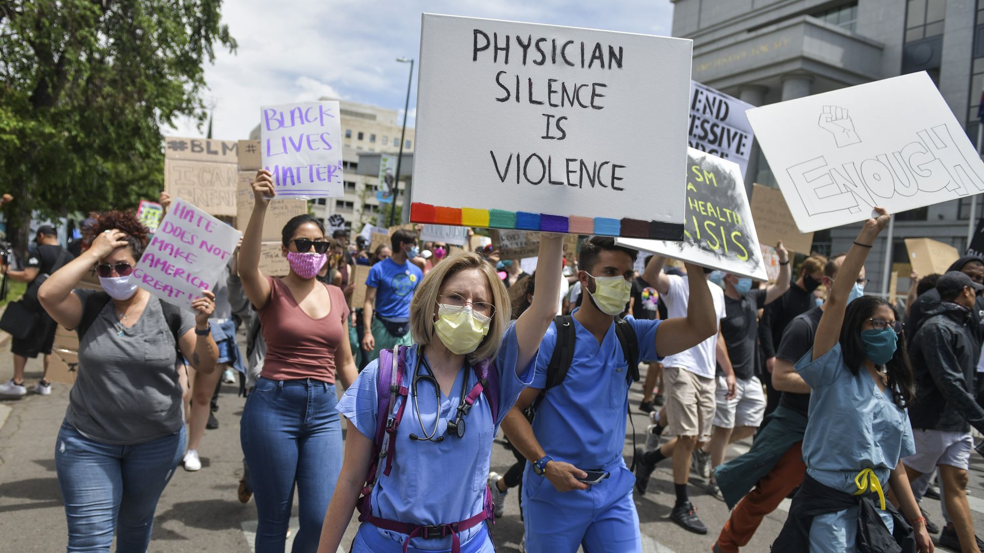 Physicians march with people protesting in Denver, Colorado