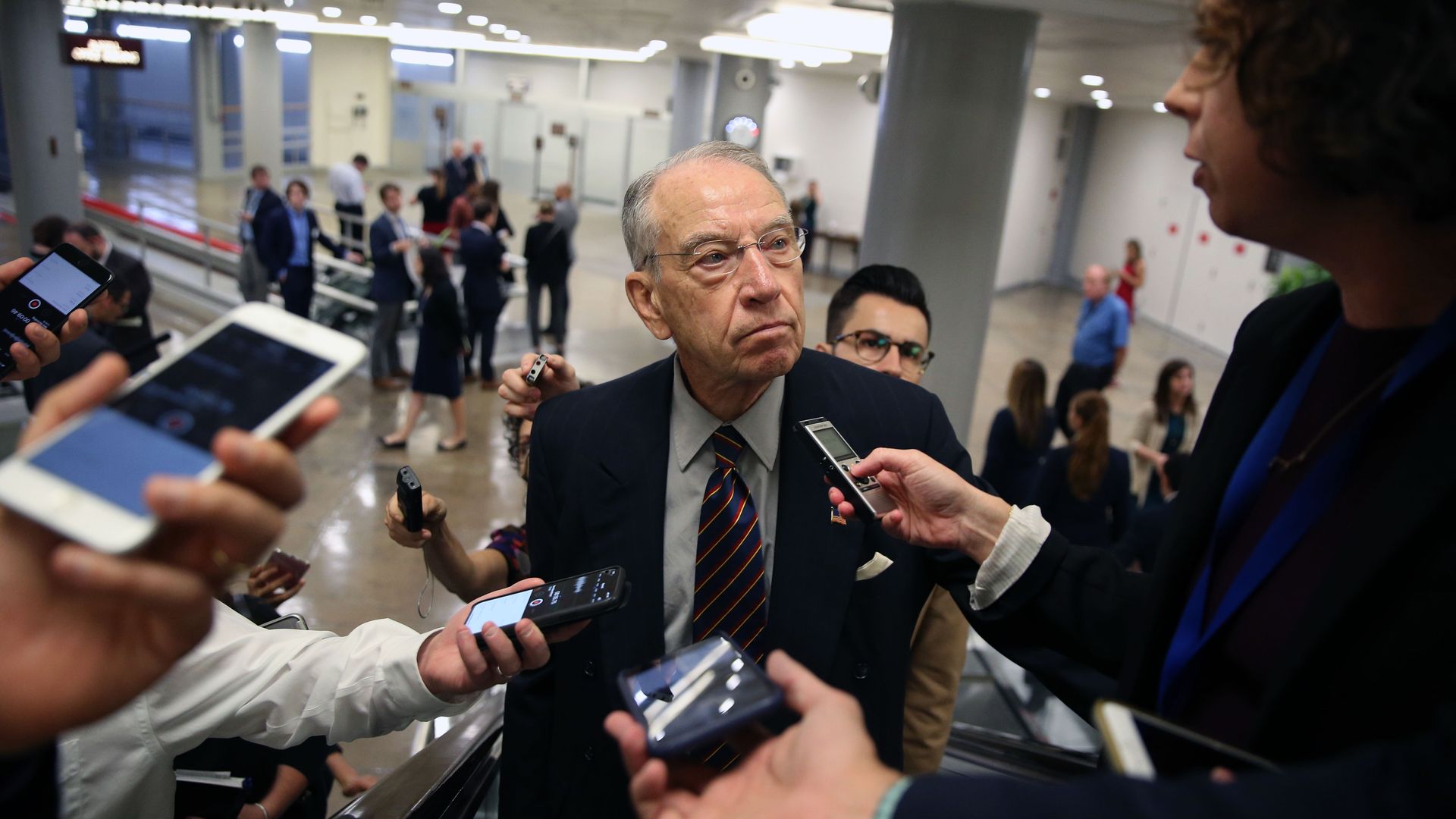 Chuck Grassley surrounded by reporters.