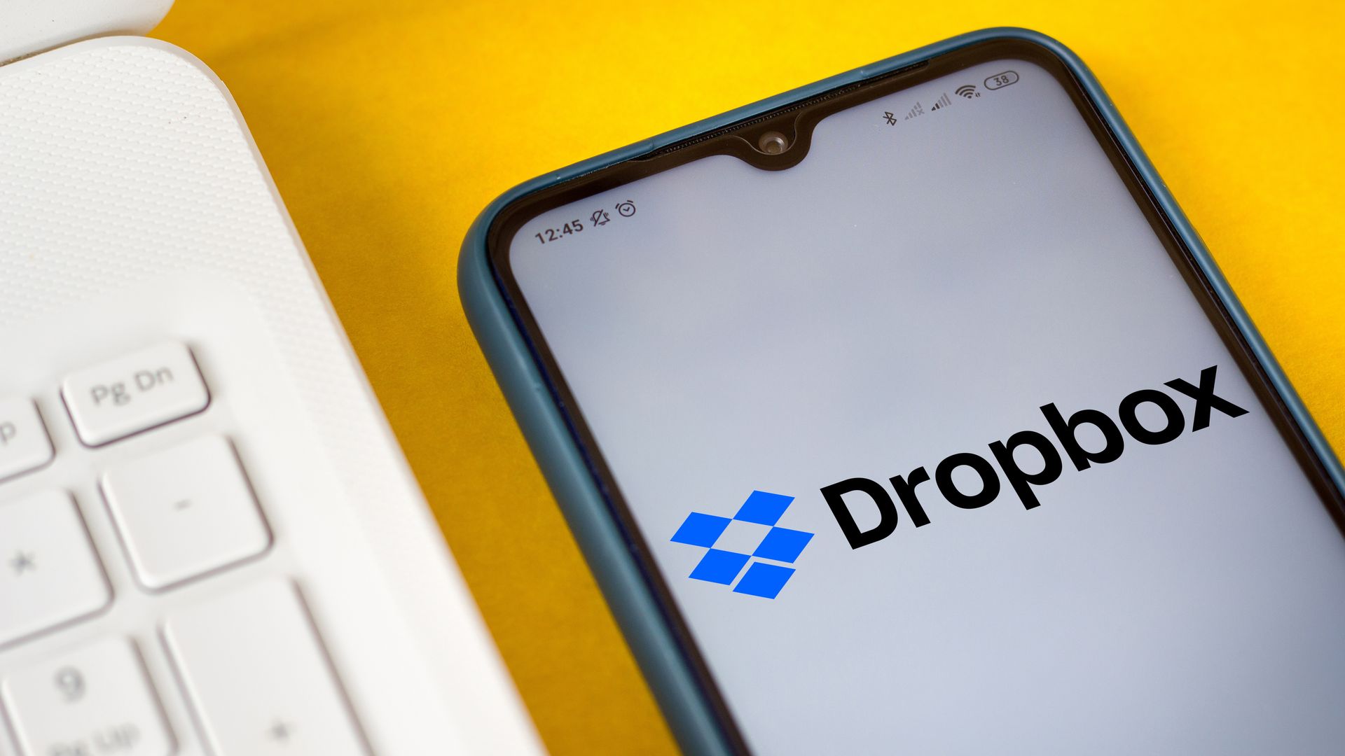 A photo of a smartphone displaying the Dropbox logo