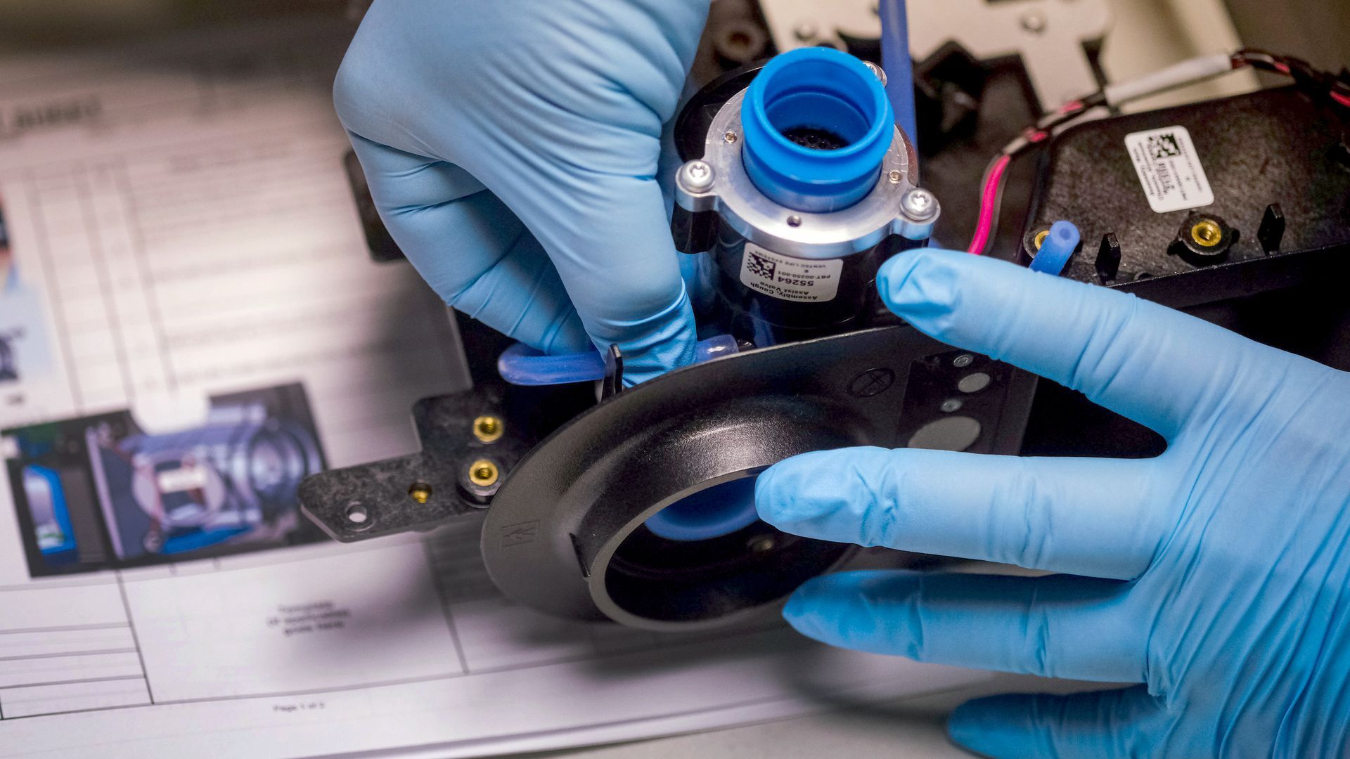 gloved hands making a ventilators