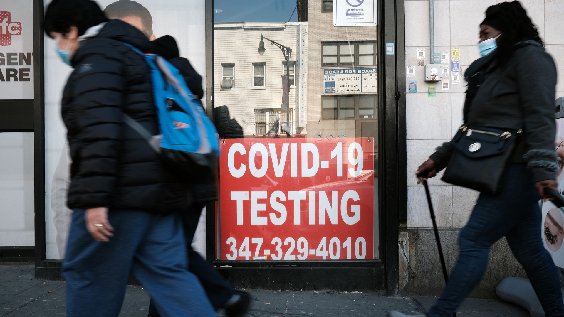 People walking past a sign for coronavirus testing in the South Bronx on March 10.