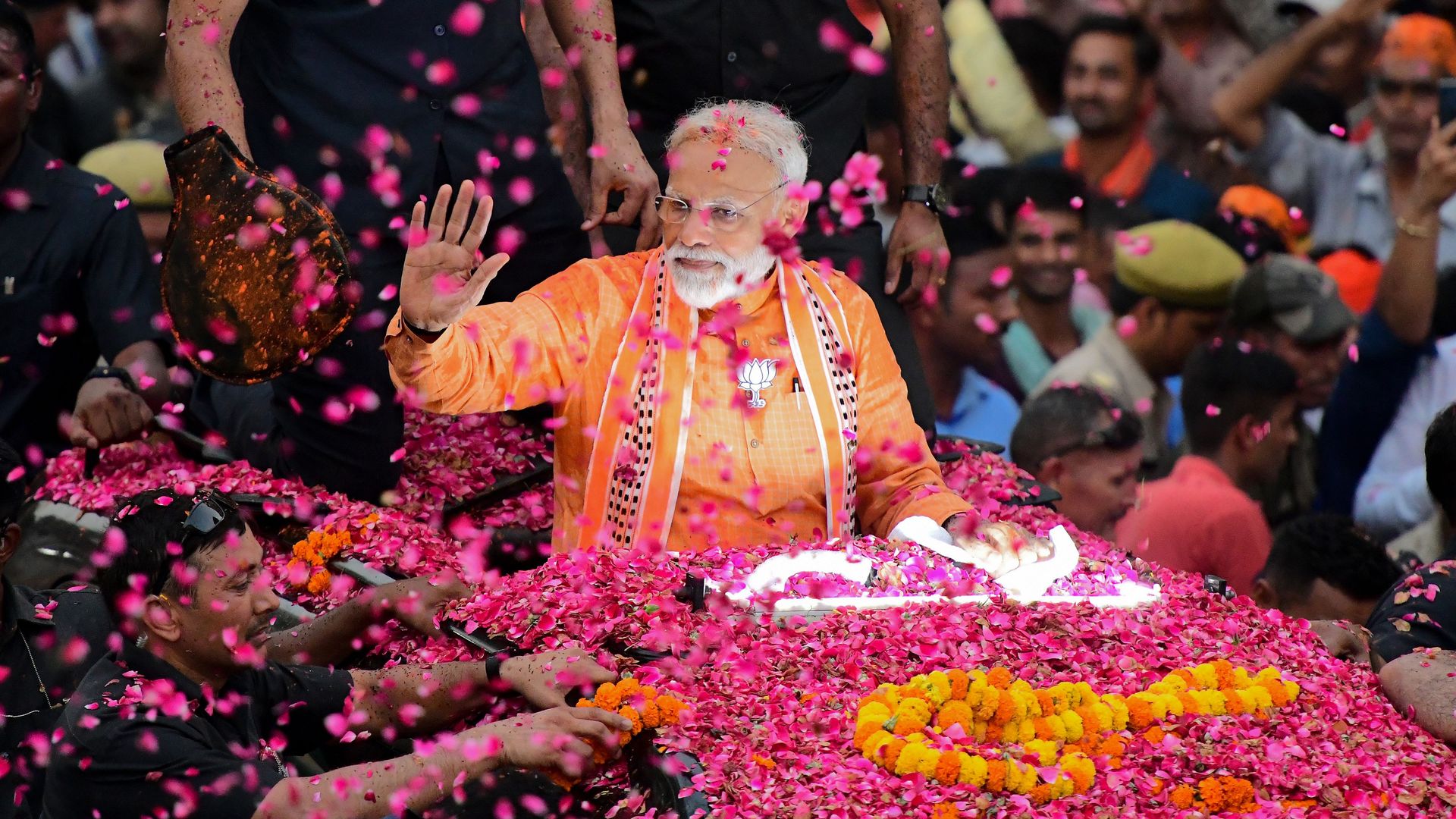   Indian Prime Minister and leader of the Bharatiya Janata Party (BJP) Narendra Modi gestures during a roadshow in Varanasi on April 25, 2019.