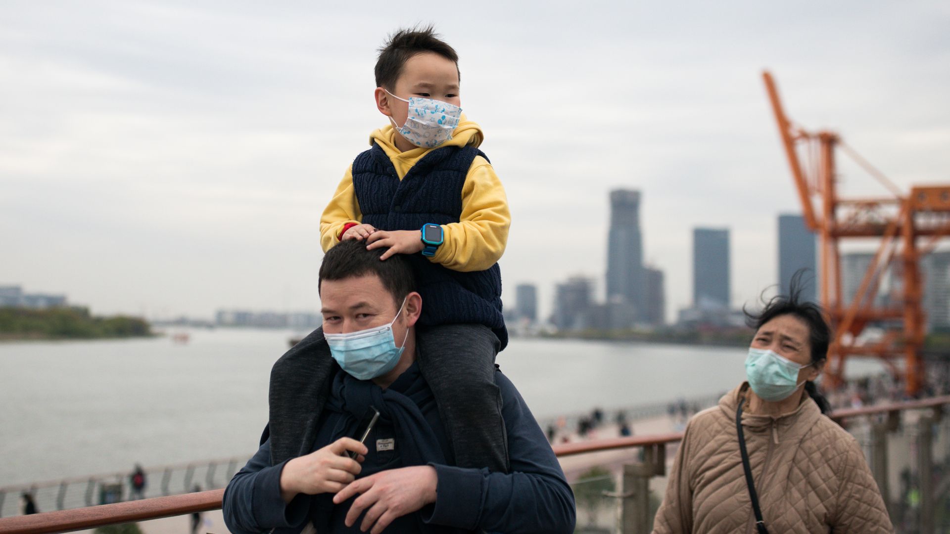 Picture of a man carrying a kid on his shoulders