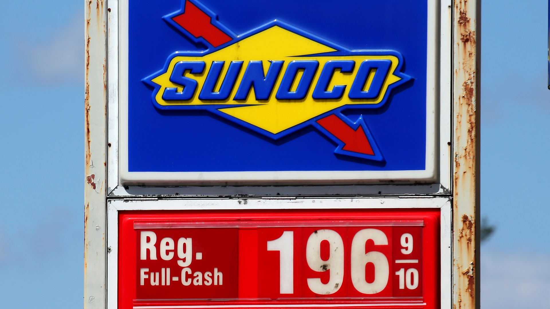 A sign at a Sunoco gas station listing gas prices at $1.96 a gallon