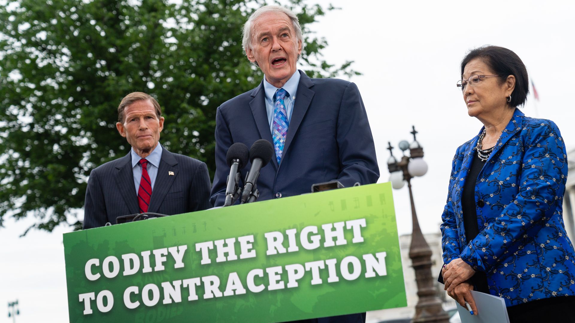 Picture of Ed Markey in front of a sign that says "codify the right to contraception"