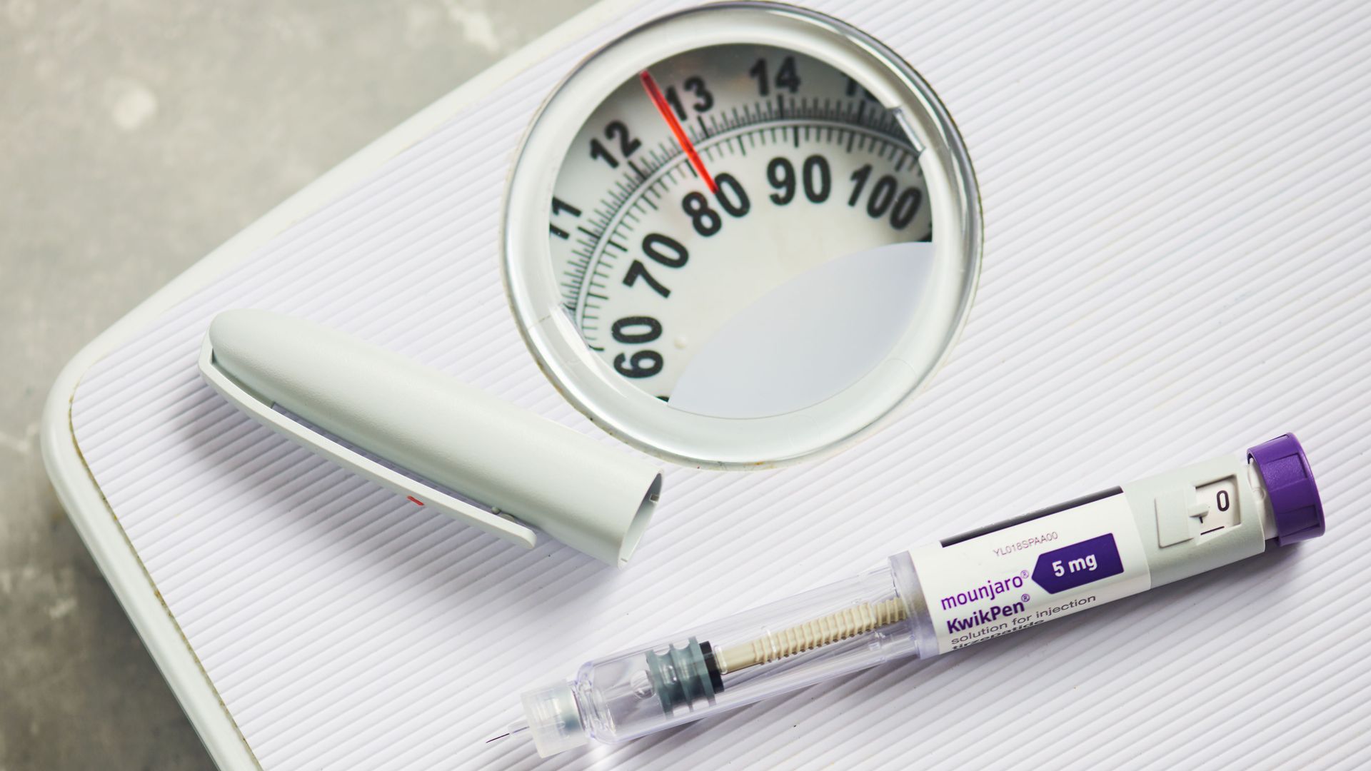 Photo illo of Eli Lilly's Mounjaro on a scale