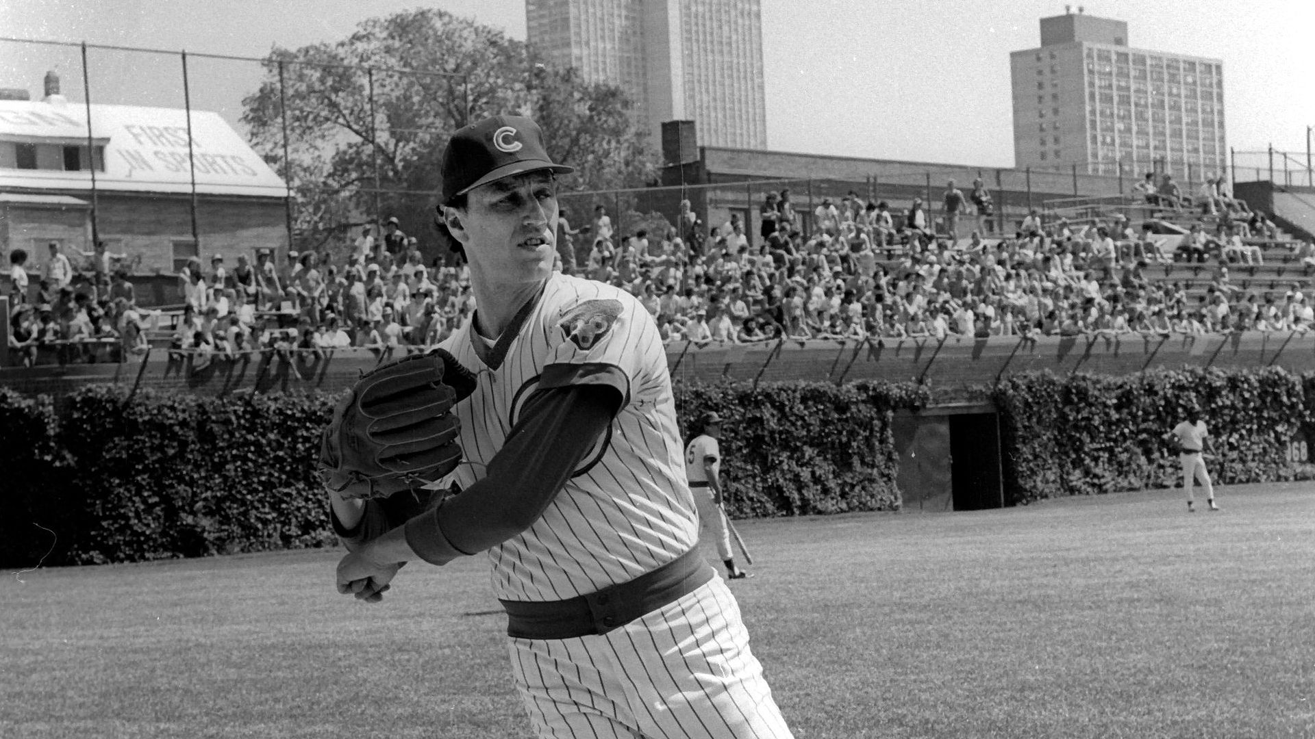 A black-and-white photo of Chicago Cubs pitcher Kenny Holtzman practicing before a MLB game at Wrigley Field in Chicago.