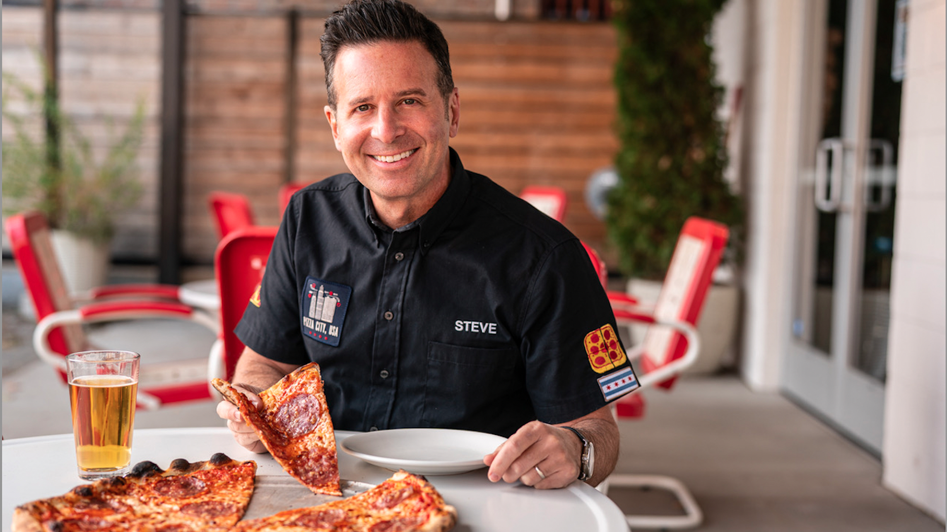 Guy with beer and pizza.