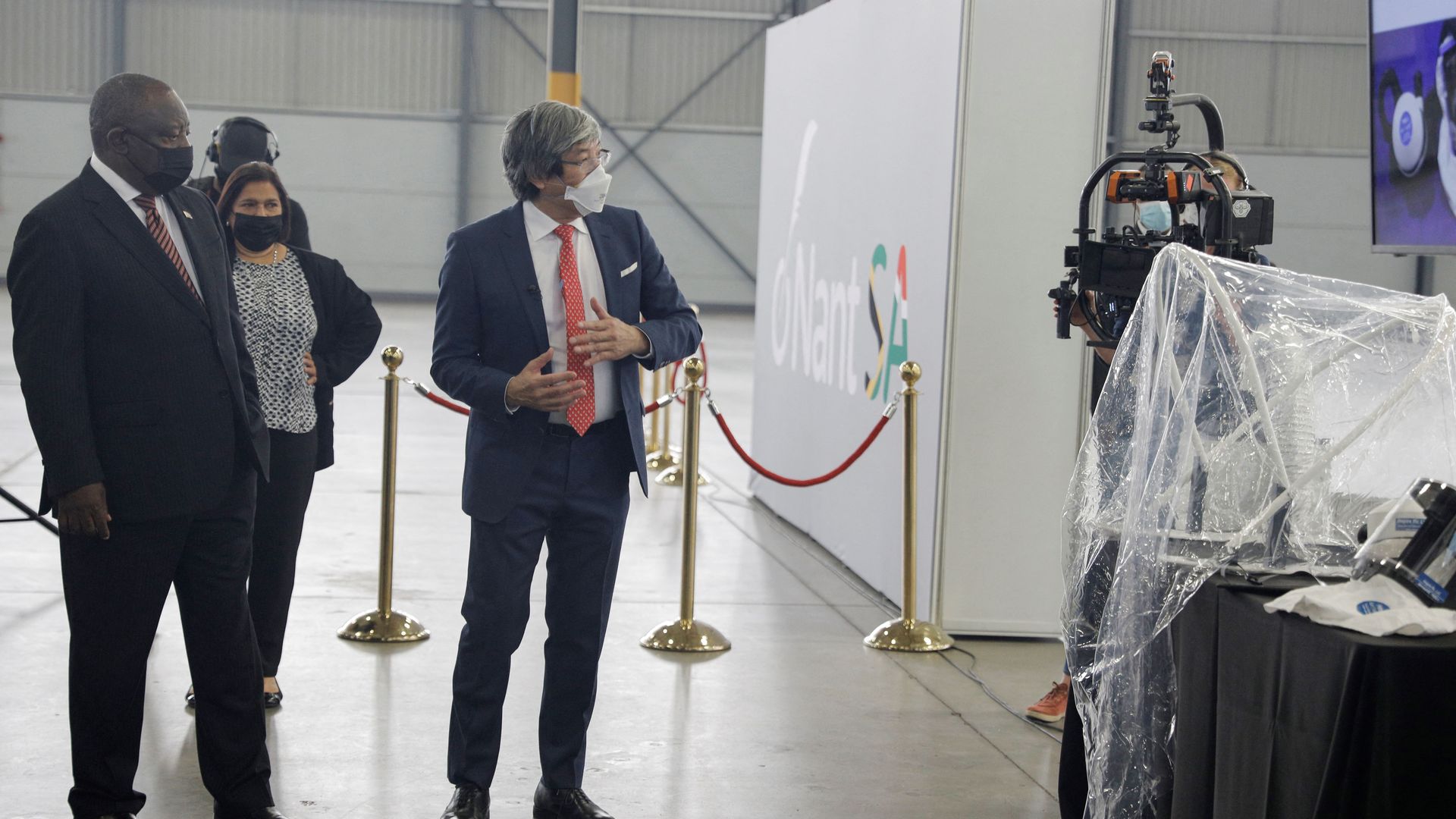 South African President Cyril Ramaphosa (L) and founder of NantWorks Dr Patrick Soon-Shiong (R) tour the facility during the launch of NantSA, the future vaccine manufacturing campus in South Africa.