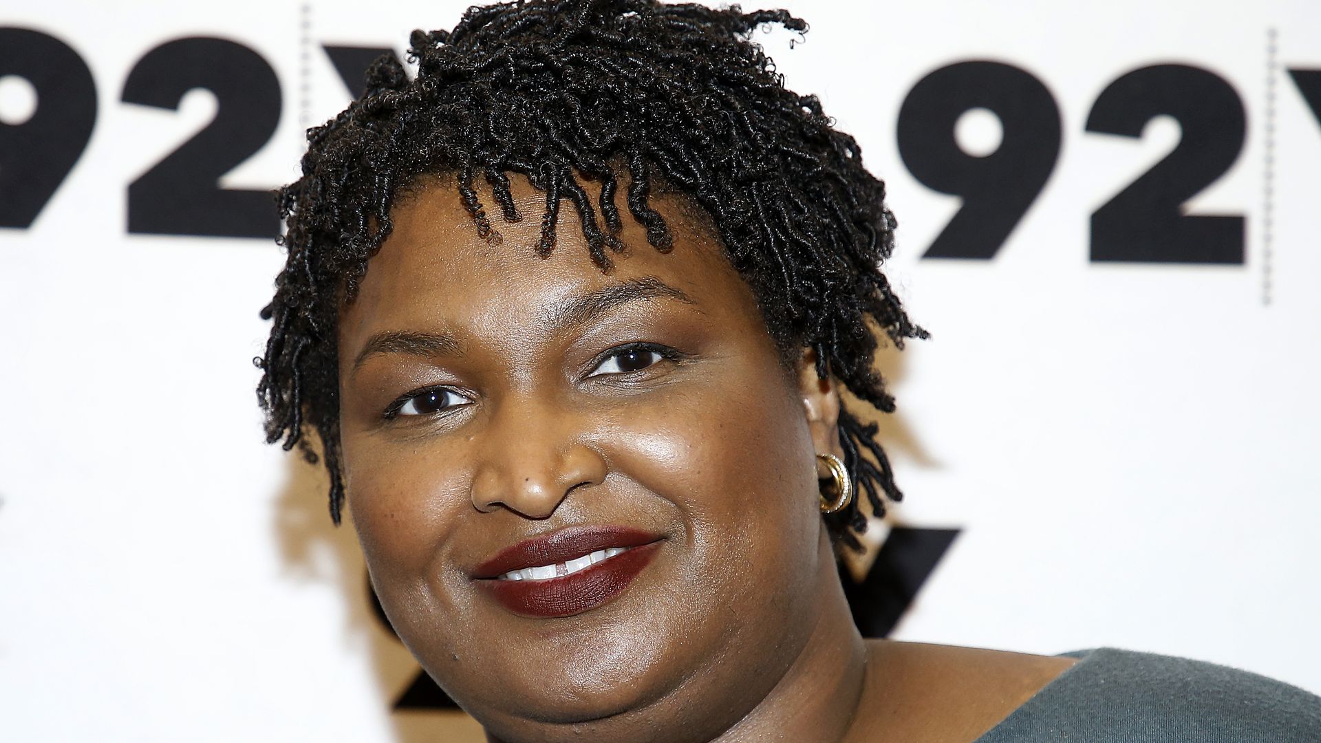 In this image, Stacey Abrams smiles at a camera.