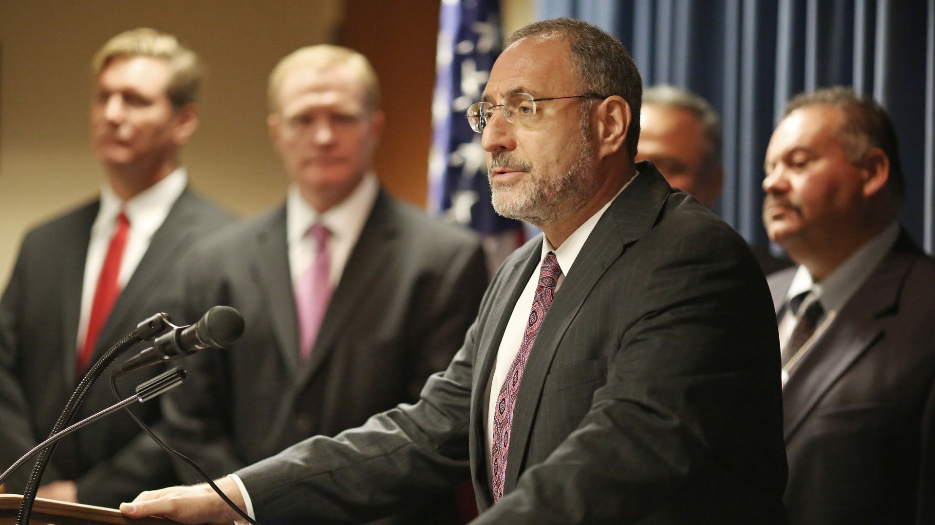 A photo of U.S. Attorney Andrew Luger speaking at a news conference.