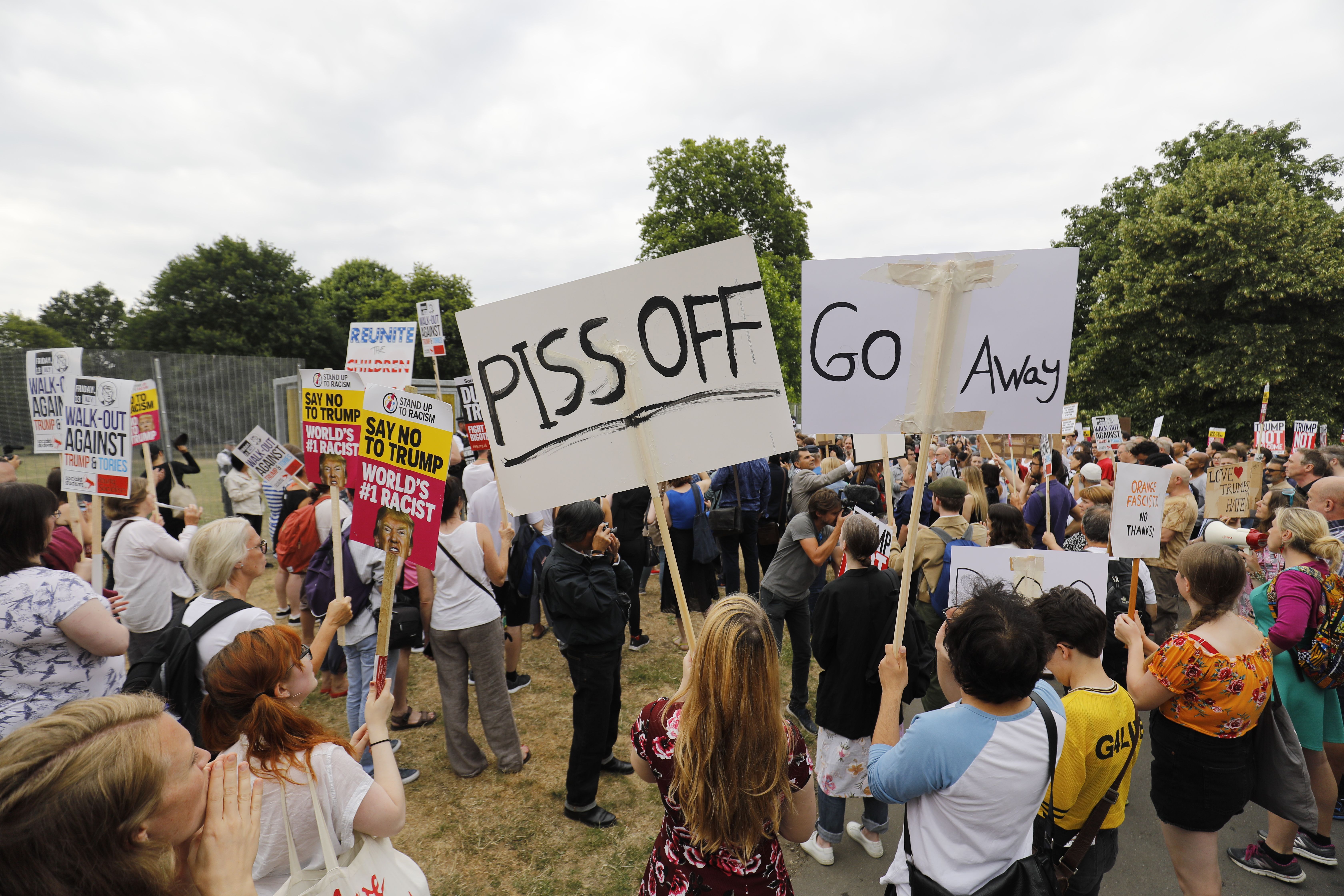Protestors in London wave signs against Trump