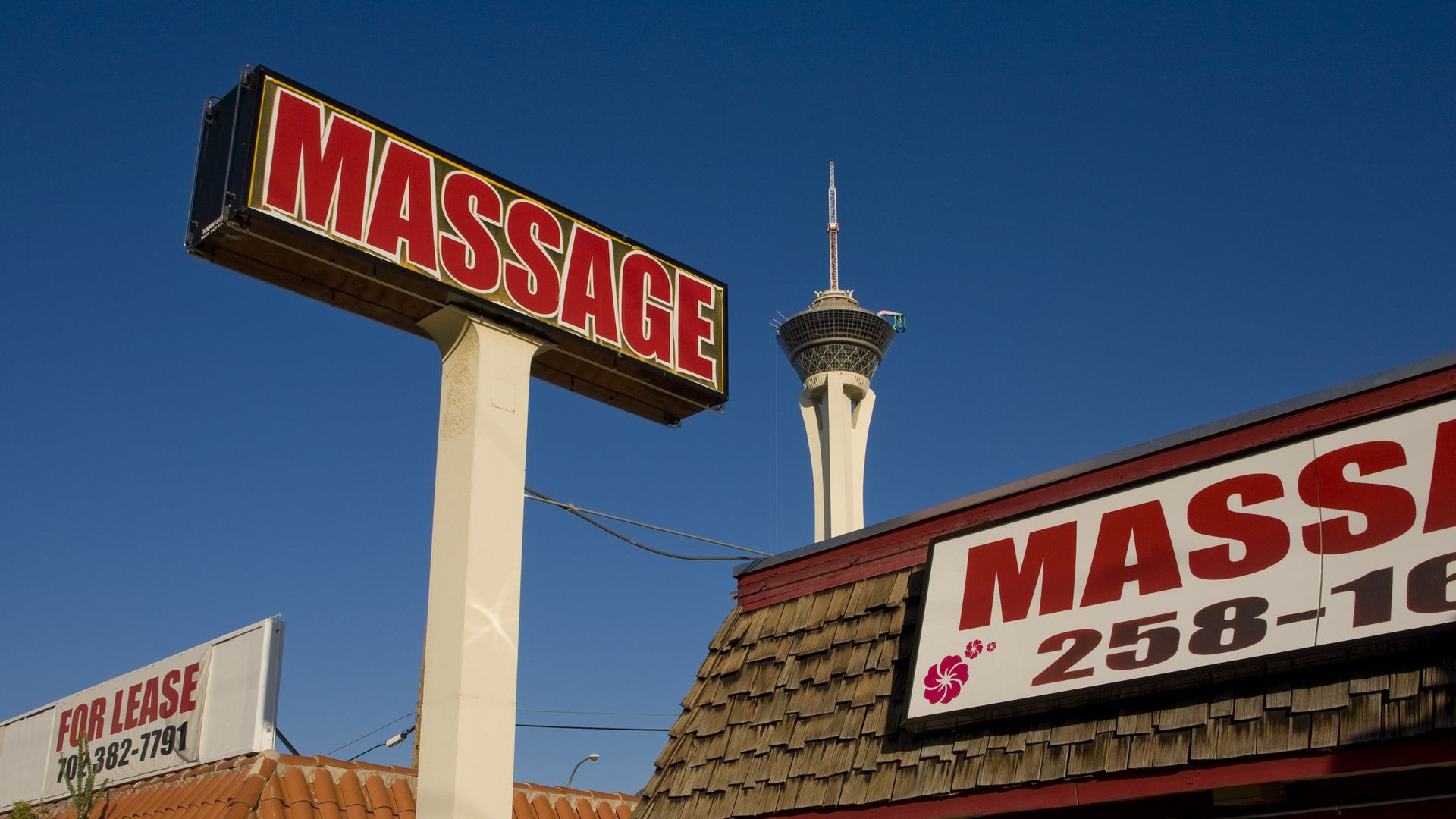 A sign that says "massage" outside a building