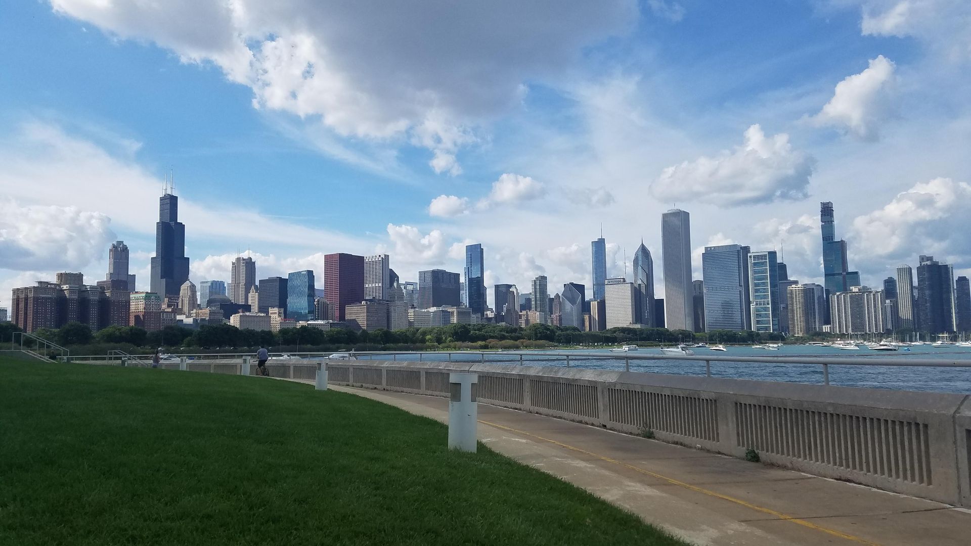 Photo of a some clouds hanging over a city skyline. 