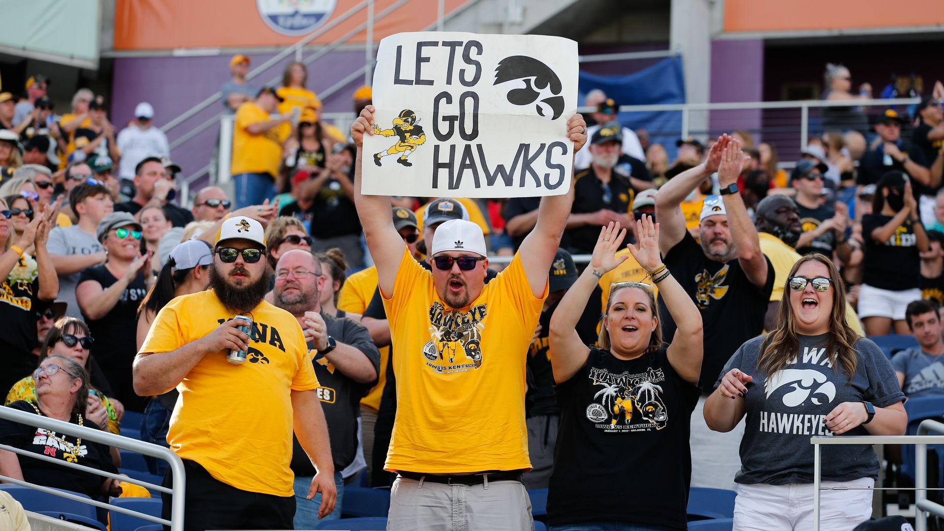 Iowa Hawkeyes fans cheering at a football game