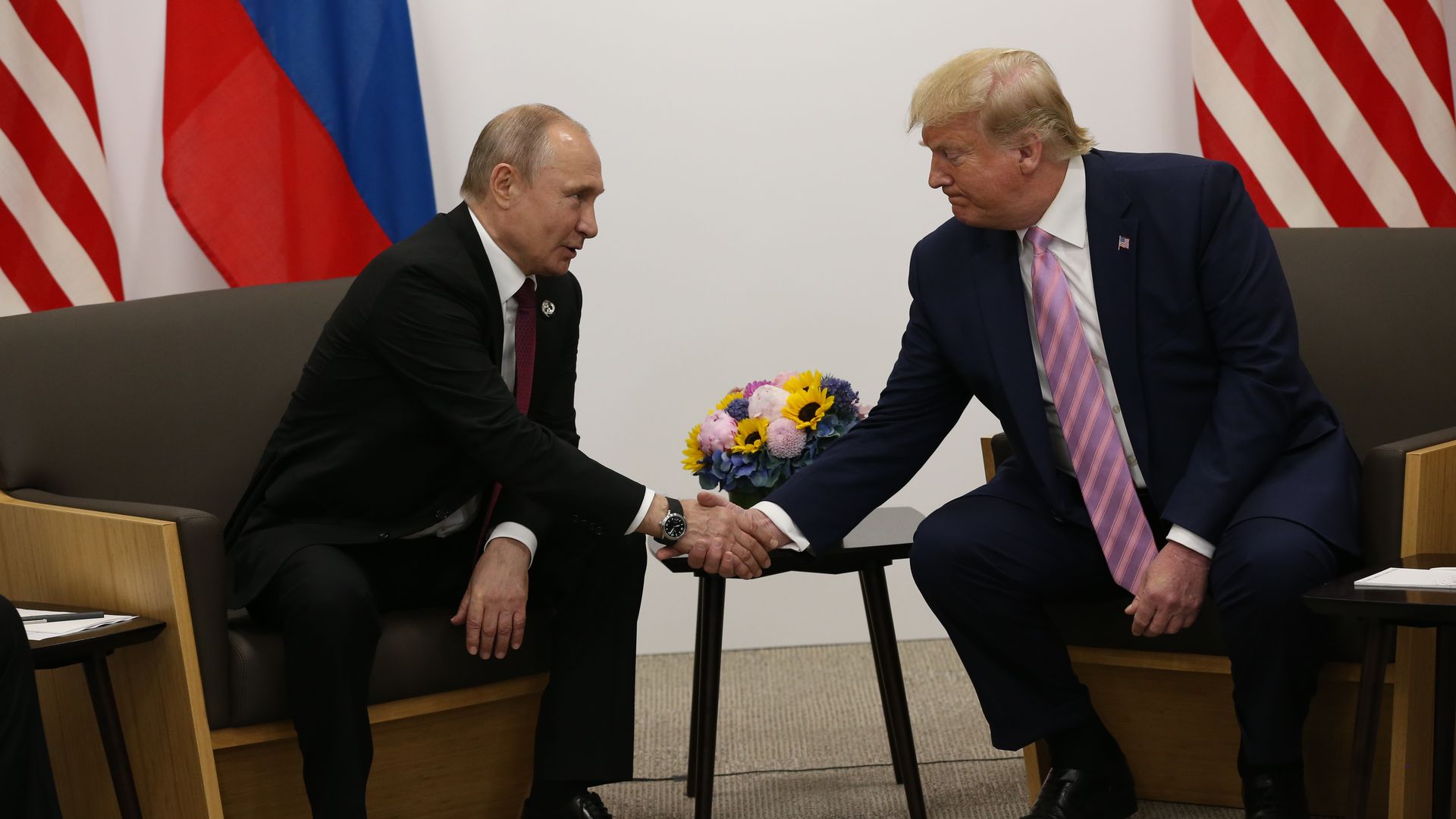 President Trump and Russian President Vladimir Putin shaking hands