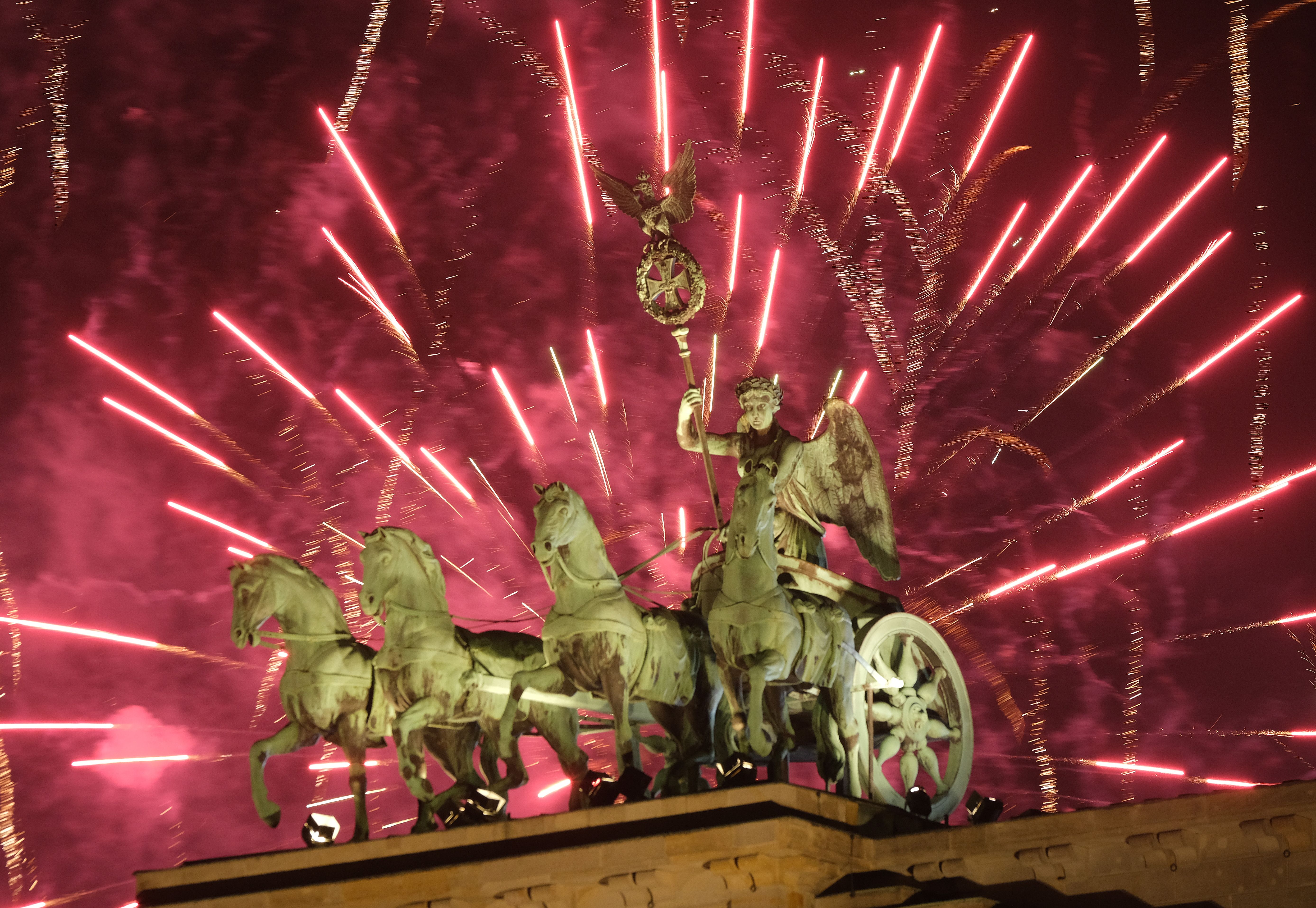 he Quadriga statue stands on the Brandenburg Gate during New Year's Eve fireworks on January 01
