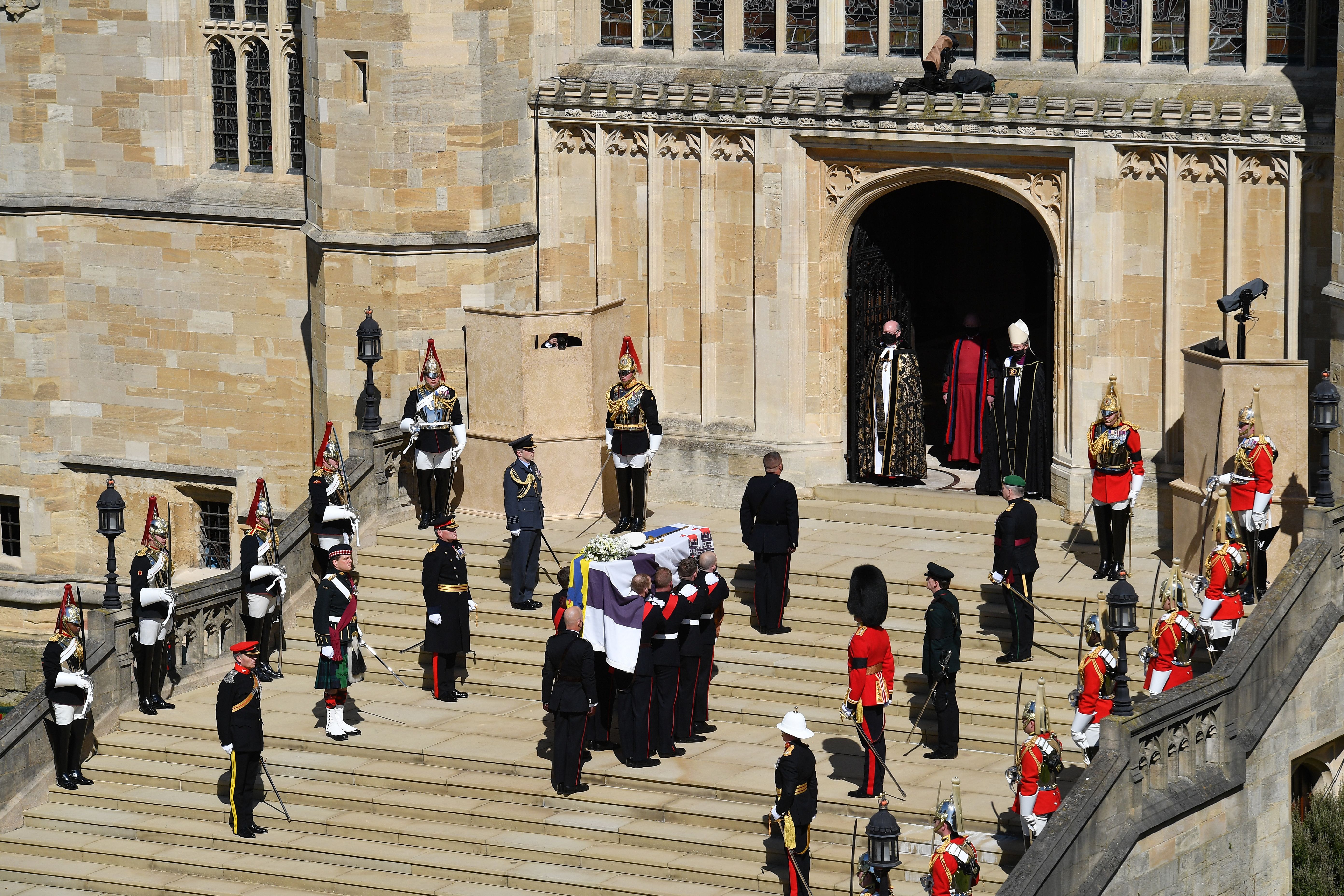 Photo of Prince Philip's coffin being carried up the stairs in St. George's chapel
