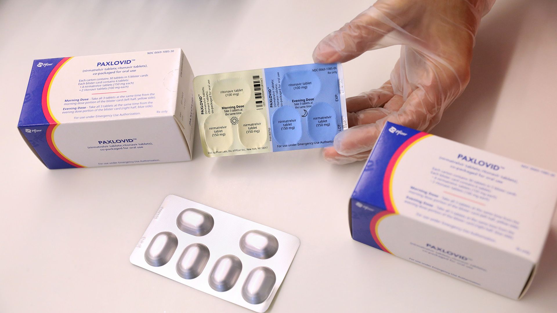 A person holds packets of the antiviral drug Paxlovid