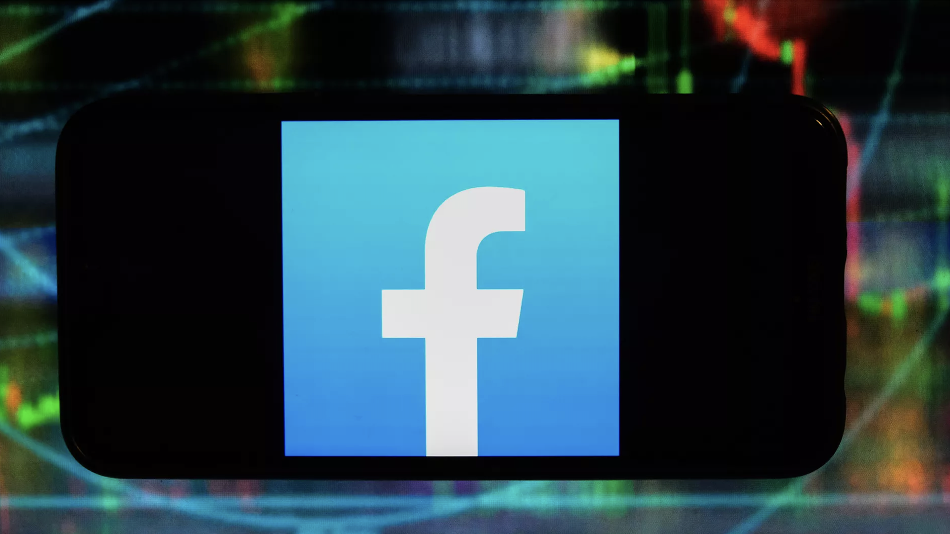A photo illustration of the Facebook logo on a smartphone.
