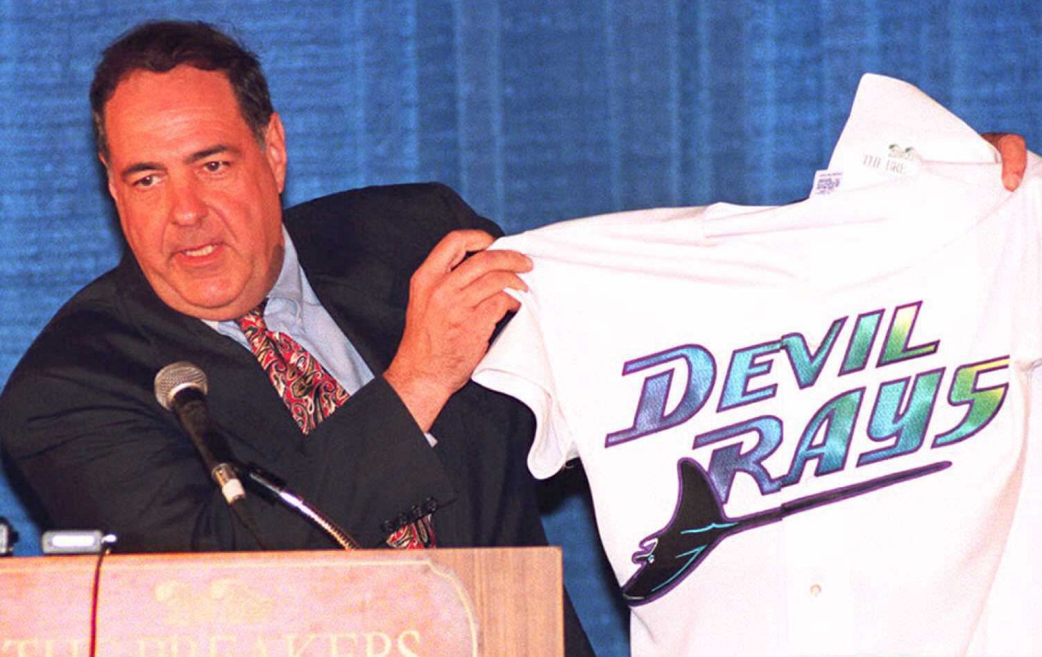 Owner holding up a Devil Rays shirt