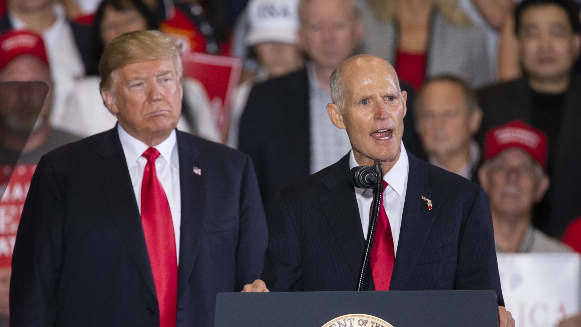 President Trump stands with Rick Scott at a campaign rally
