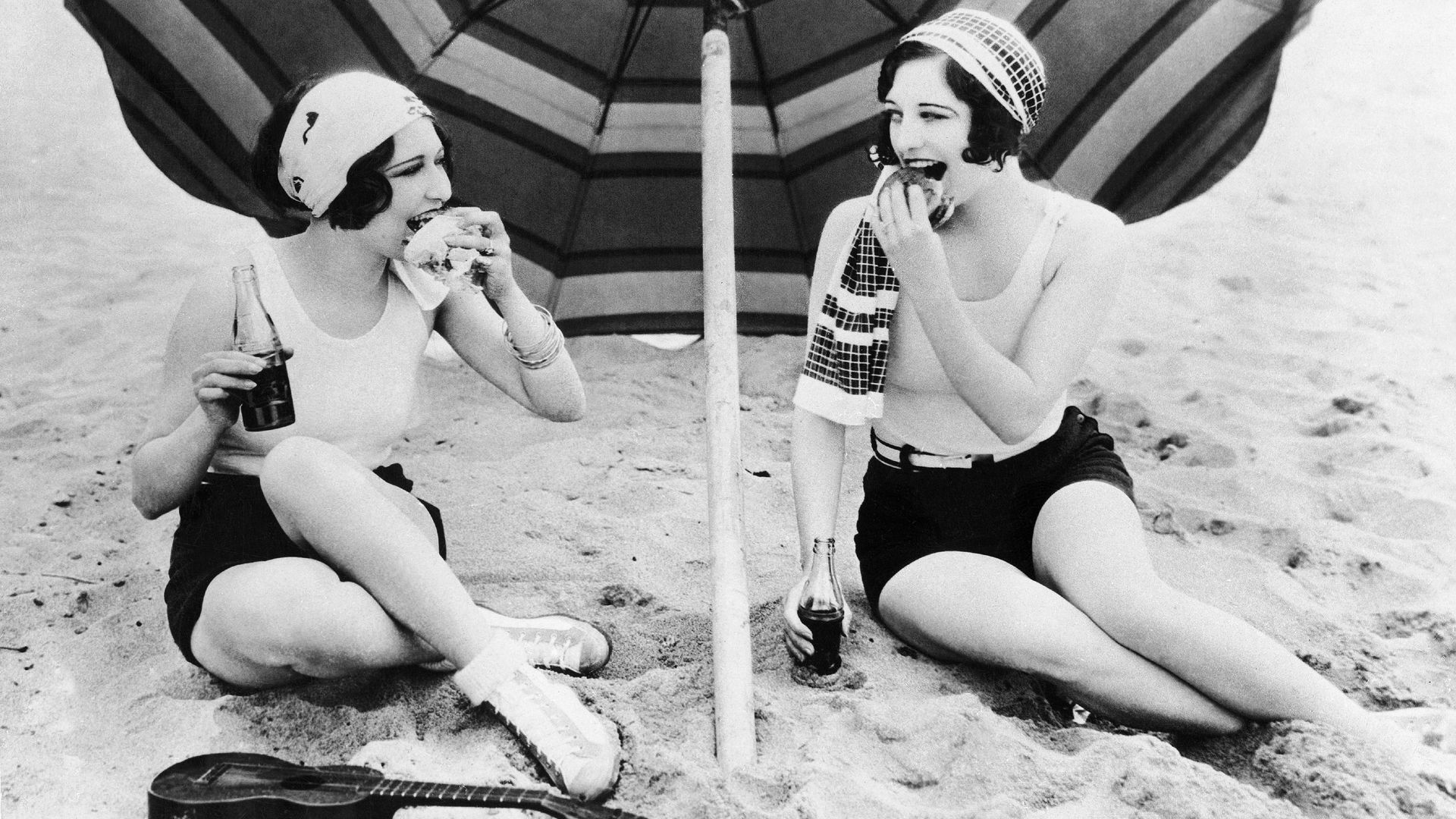 Actresses Dorothy Sebastian and Joan Crawford eating burgers