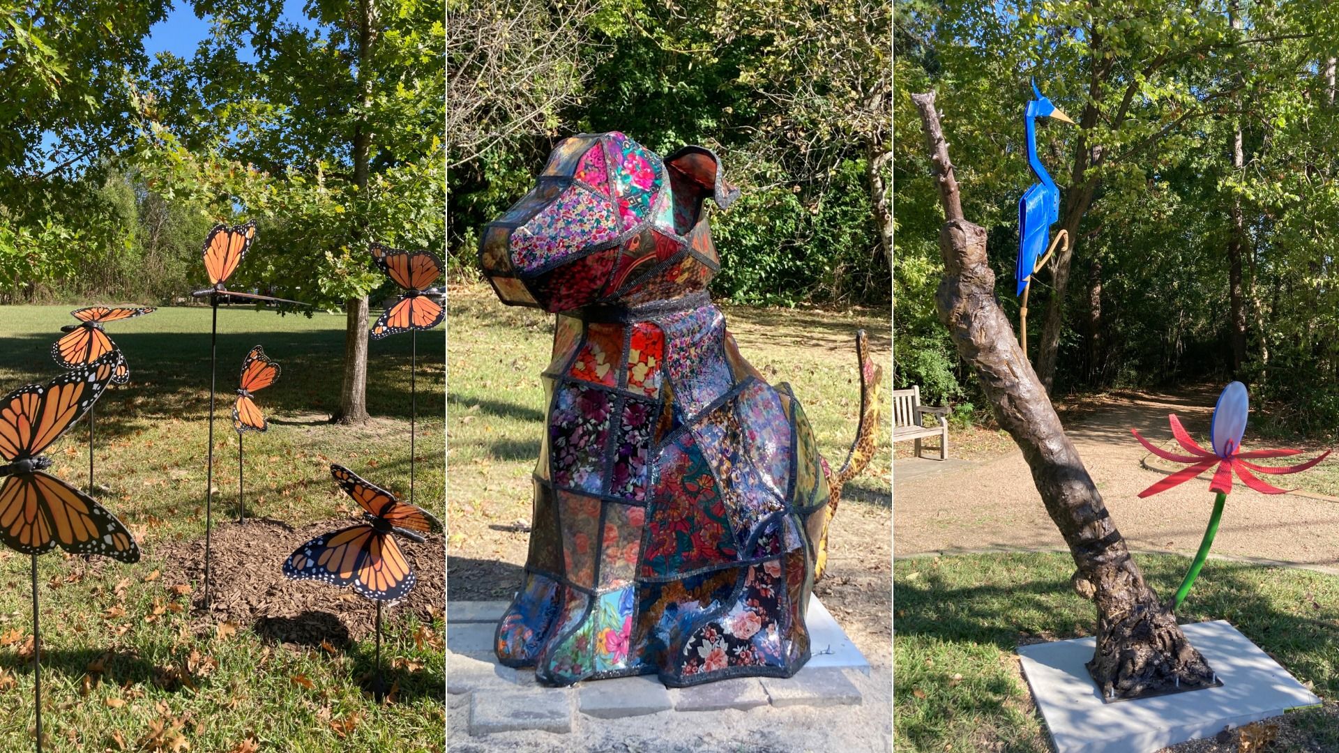 Three outdoor art sculptures: orange monarch butterflies on sticks in grass, a colorful patchwork dog sculpture, and a blue bird perched on a bent tree trunk next to a red flower.