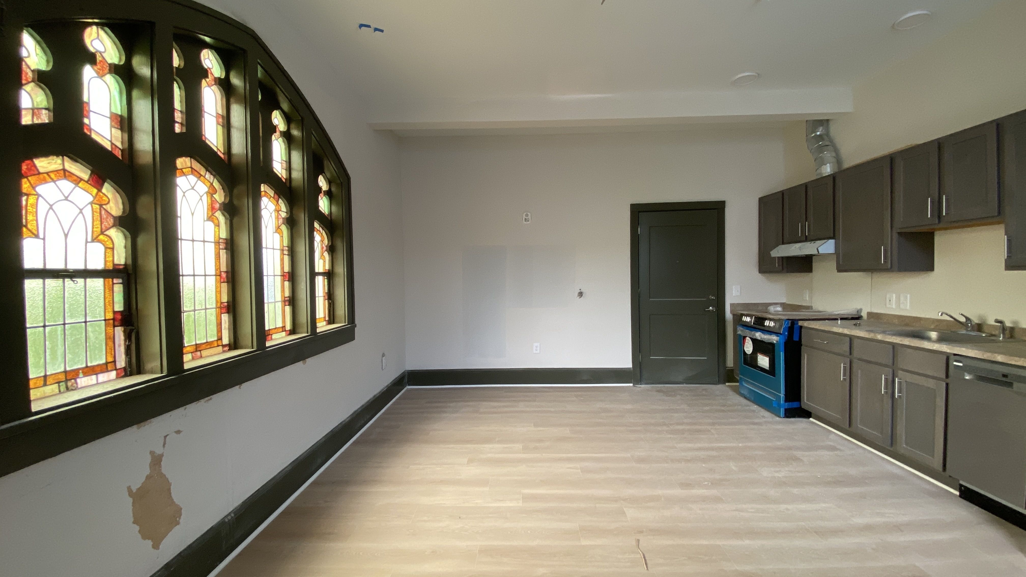 One of the 21 units at Easter's Home in Elizabeth. There's a stained glass window on the left and a kitchenette on the right. 
