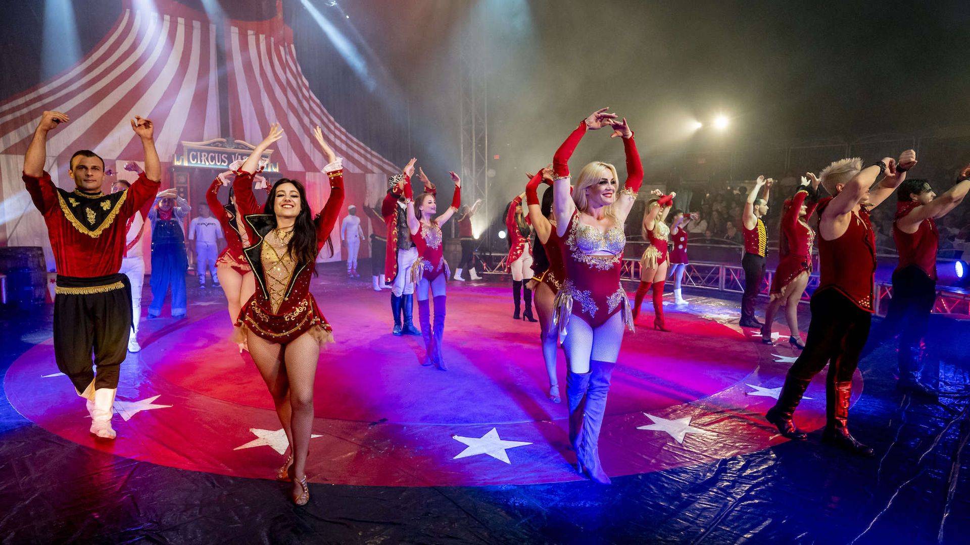 Circus performers stand for applause after the show inside the tent. 