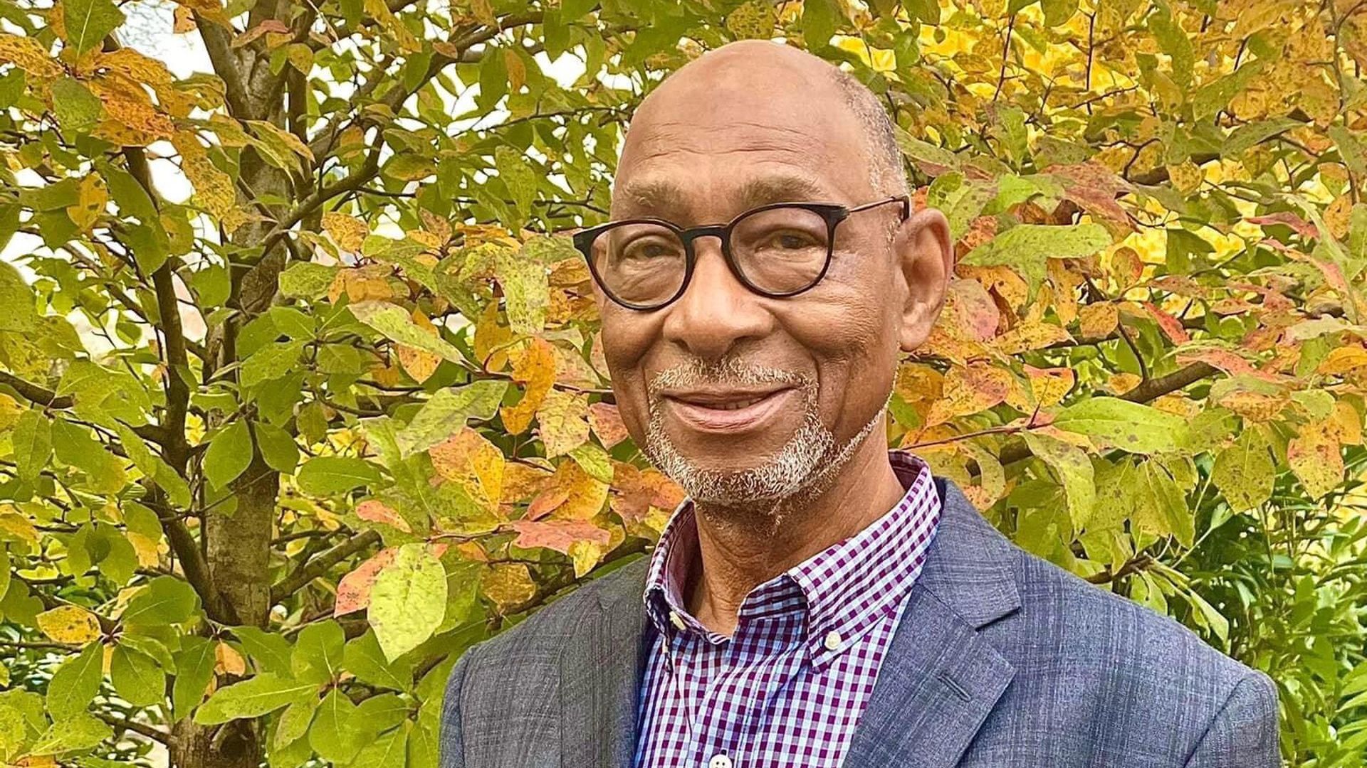 Lorenzo Washington, founder of the Jefferson Street Sound Museum, in front of fall leaves.